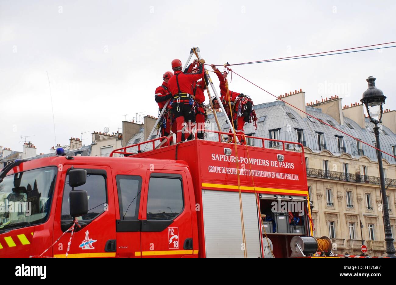 Paris fire fighters of the elite GRIMP unit (rescue under hazardous conditions) carry out a training exercise by the River Seine in Paris, France. Stock Photo