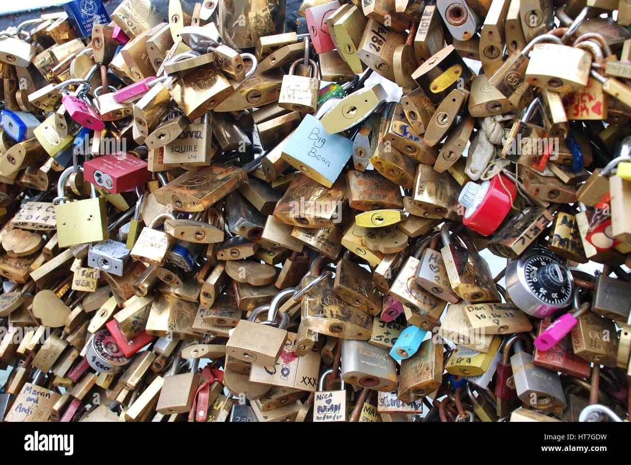 A mass of padlocks on the Pont De L' Archeveche over the River Seine in Paris, France. Visitors attach them as a public symbol of love and friendship. Stock Photo