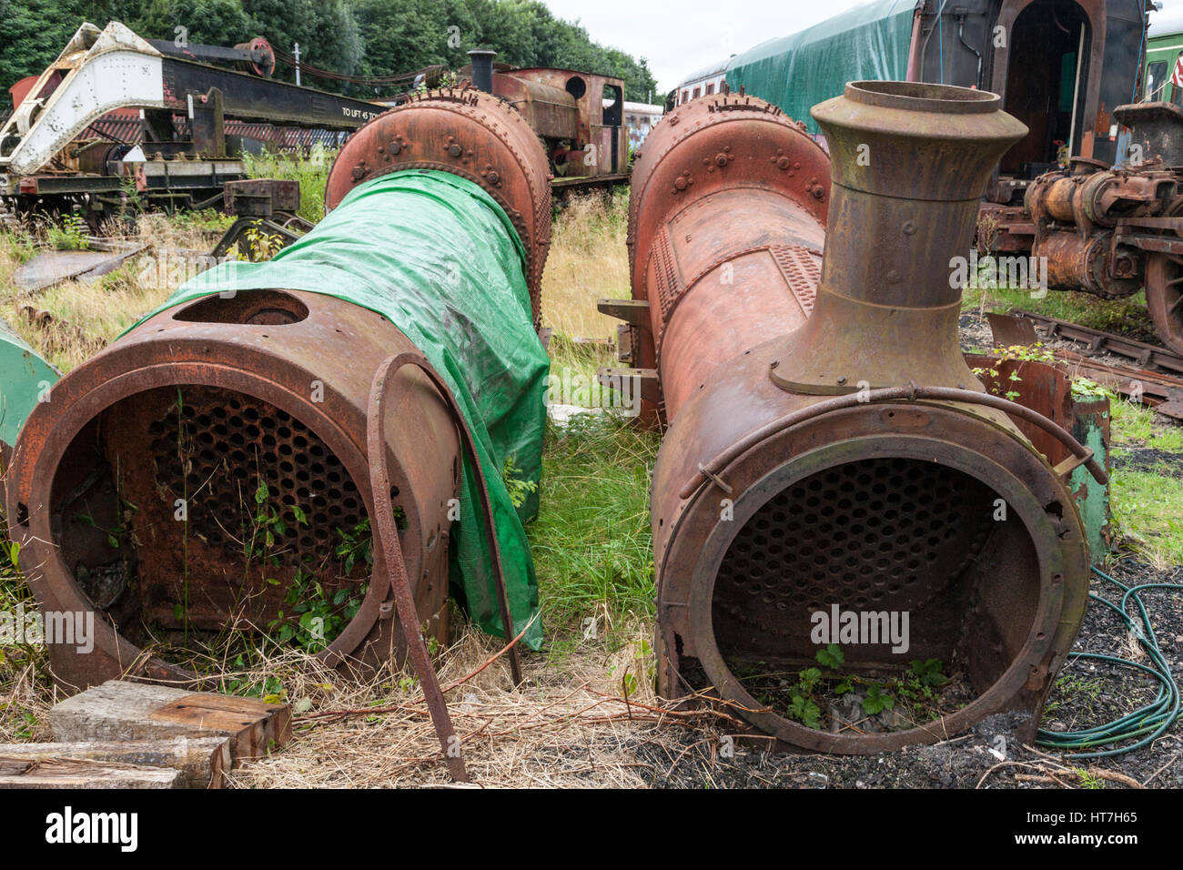 Two old steam engine boilers among other parts and rolling stock awaiting restoration, Nottingham Transport Heritage Centre, Nottinghamshire, UK Stock Photo