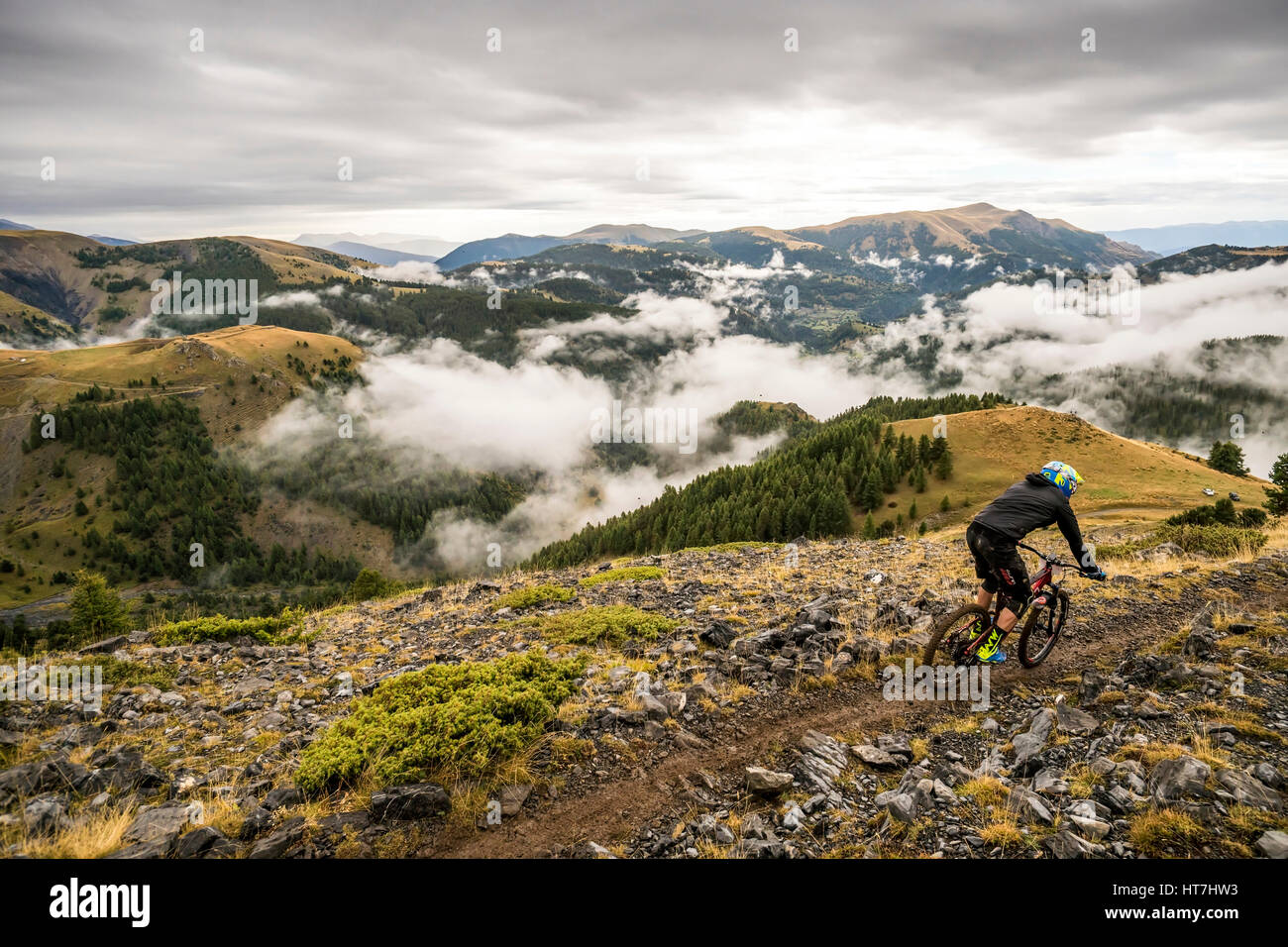 A Mountain Bike Rider Gets Some Saddle Time In A Cold Rainy Fall Day In Valberg, France Stock Photo