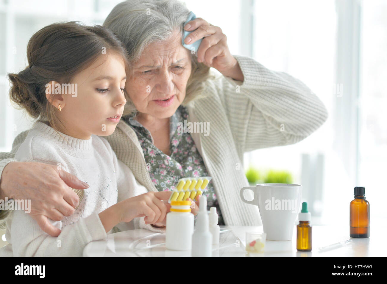 Granddaughter takes care of a sick grandmother Stock Photo