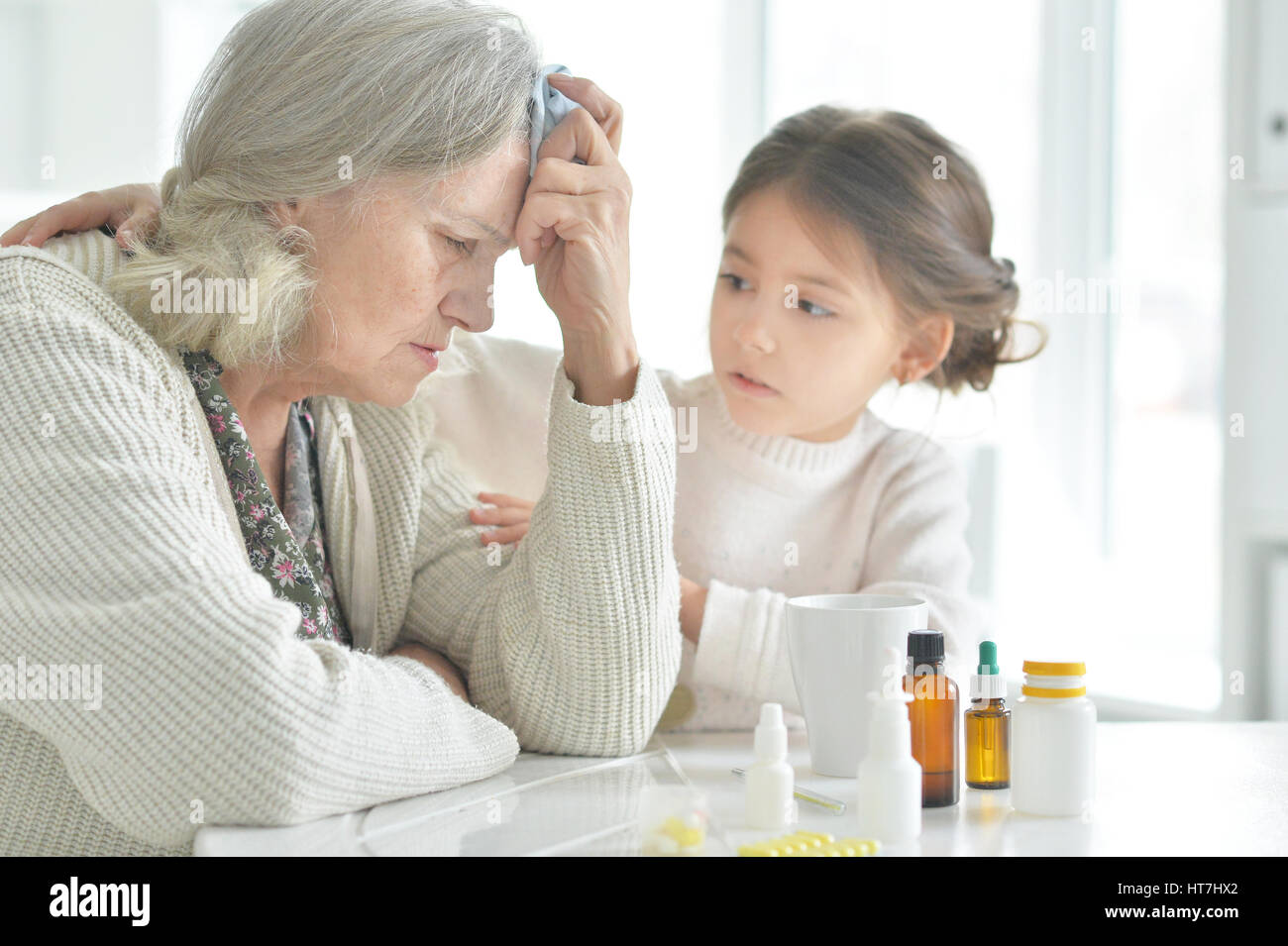 Granddaughter takes care of a sick grandmother Stock Photo