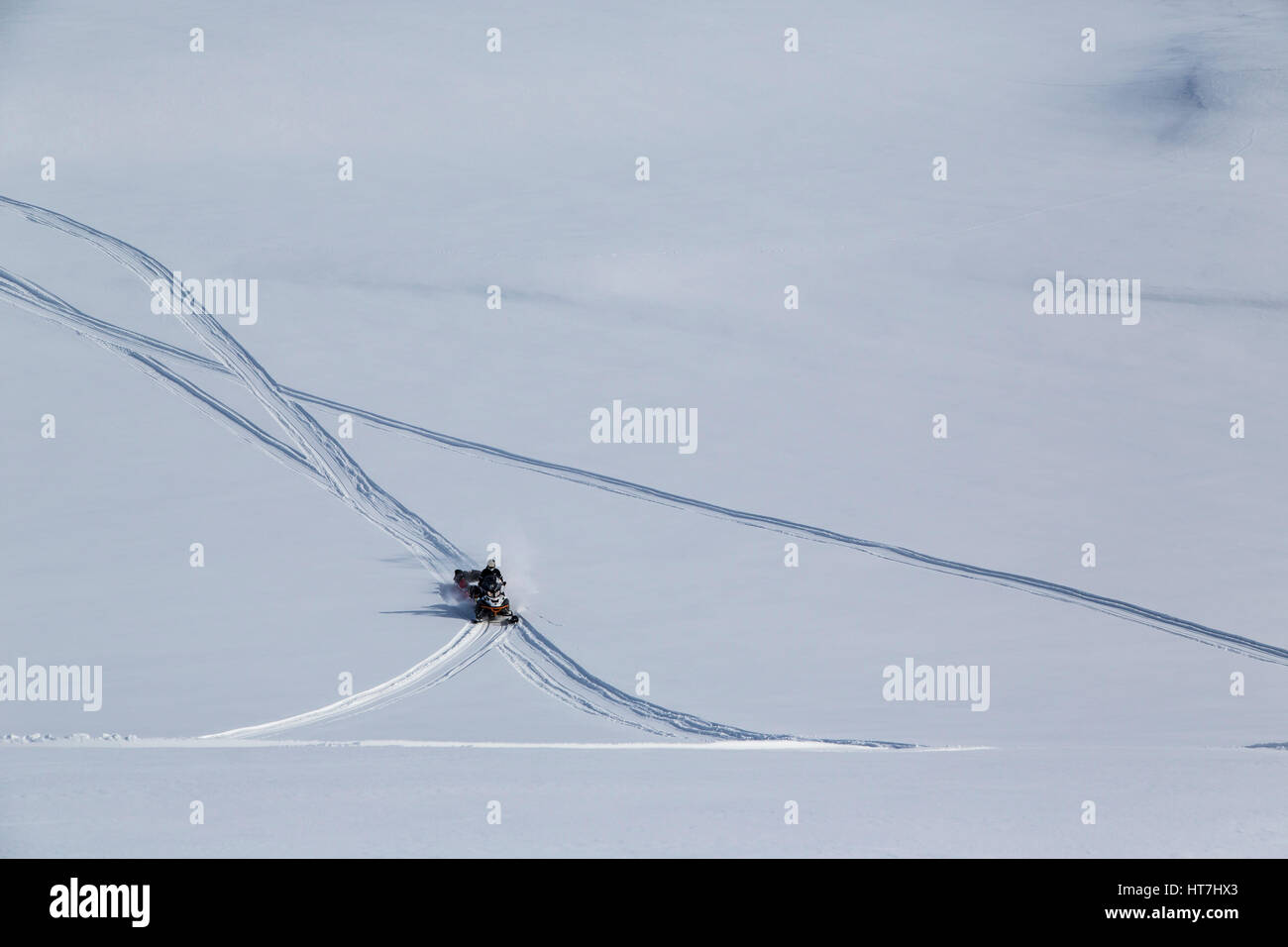 Snowmobile Expedition Crossing The Vast Plains Of Jameson Land Stock Photo