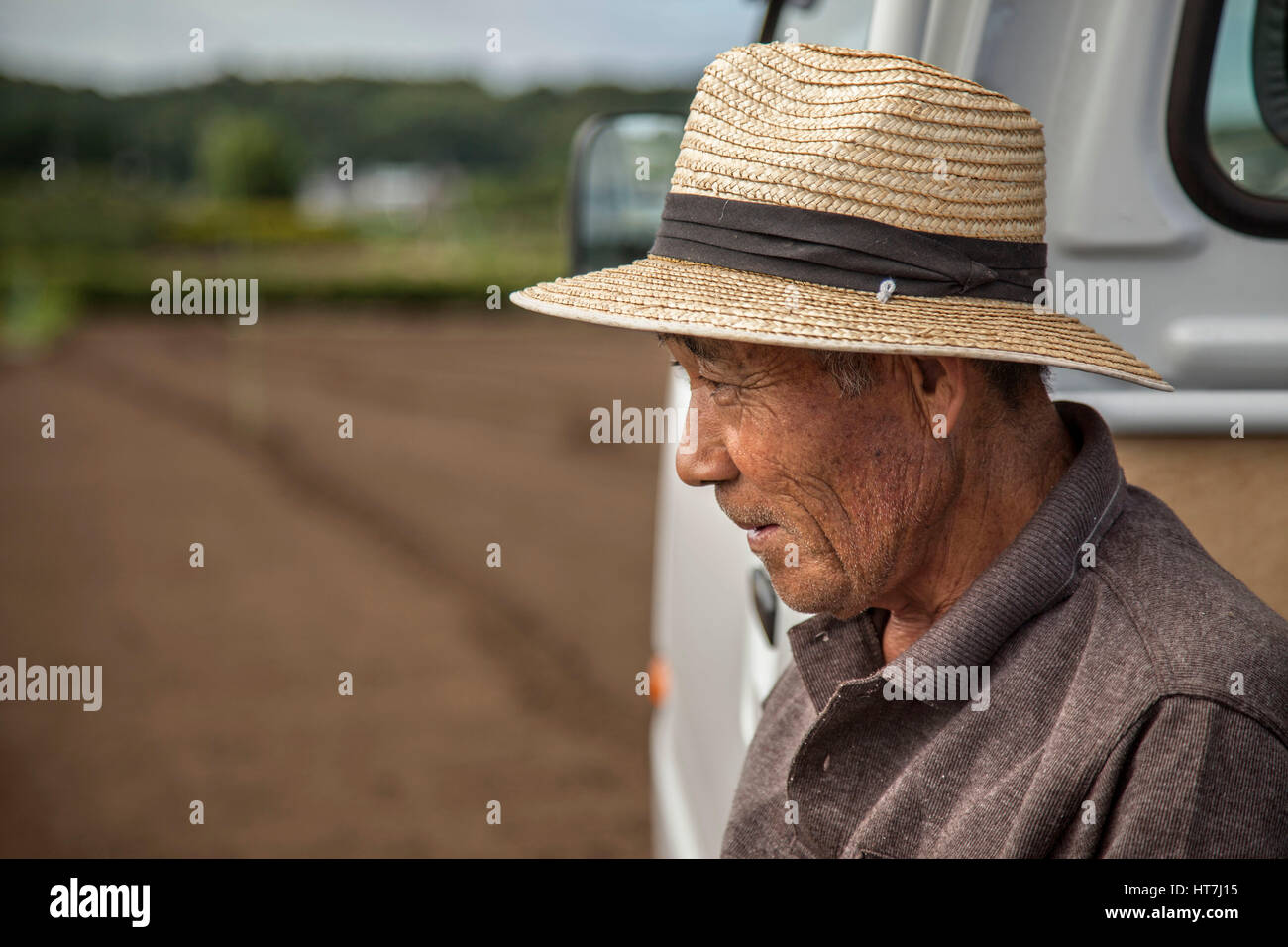 Portrait Of Japanese Farmer In Tokyo Looks Over His Day Work Stock Photo