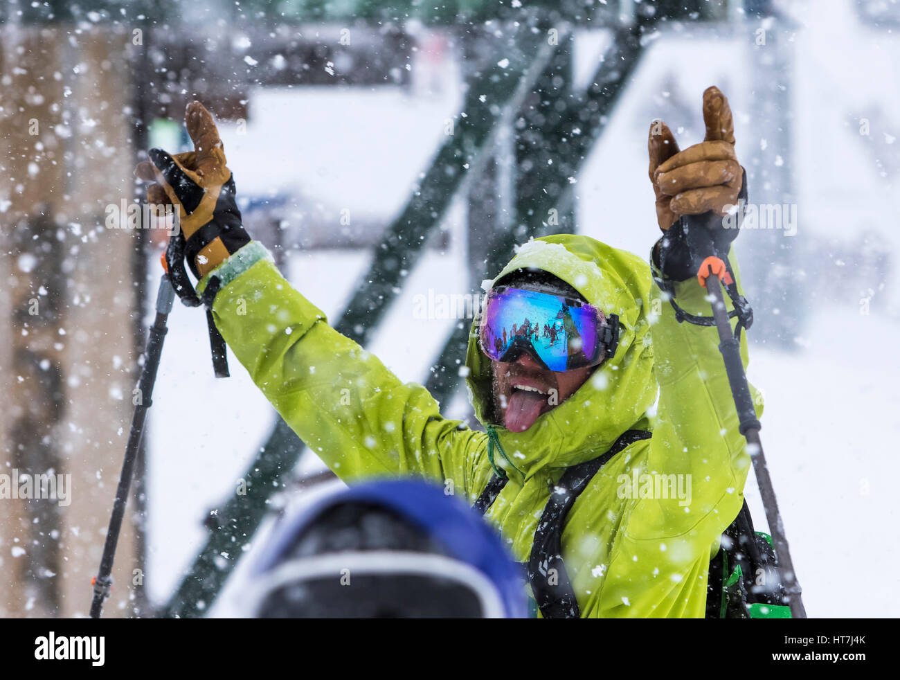 An Excited Skier Throws His Hands In The Air And Sticks Out His Tongue ...
