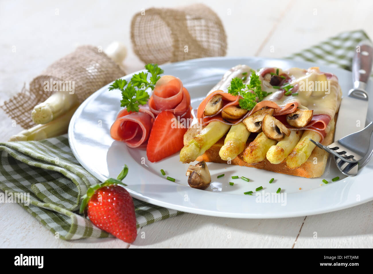 Delicious toast with fried white asparagus, Spanish Serrano ham