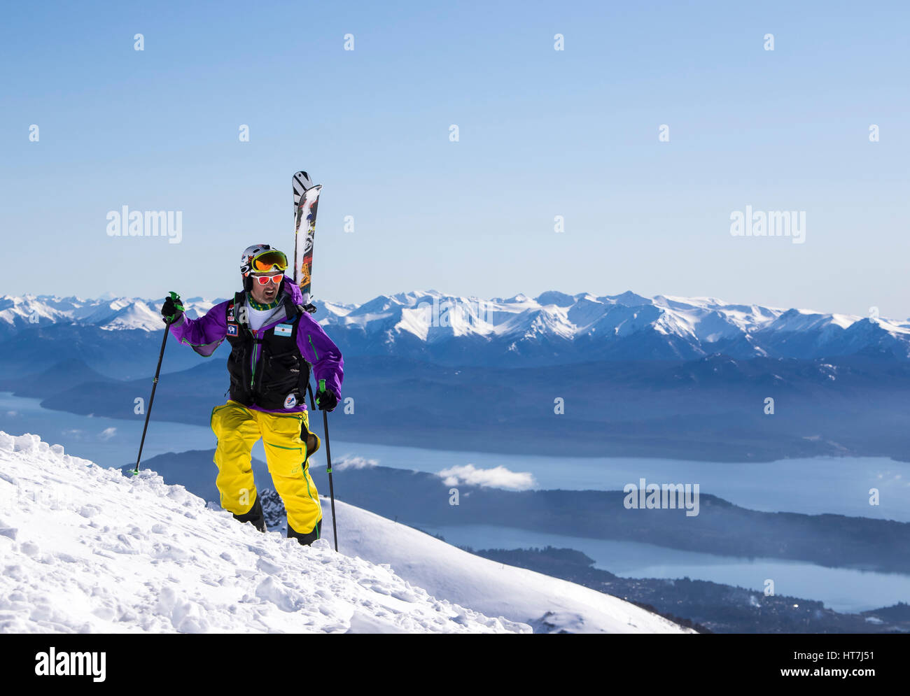 A Skier Hiking With His Skis On His Backpack Into The Backcountry
