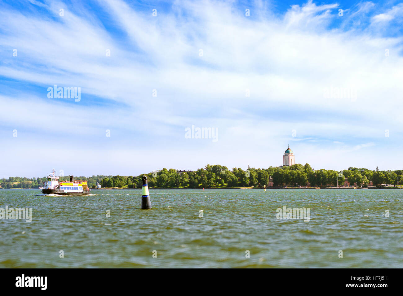 Tourist passenger boat sails near sea buoy on background of island Suomenlinna. Sea walk by motorboat in Nordic fjords. Suomi, Helsingfors, South Gulf Stock Photo
