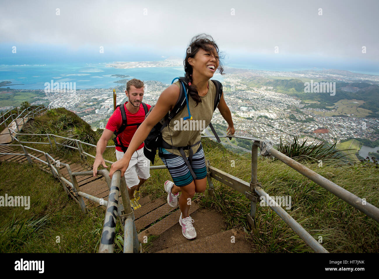 A Extreme Hiker Chase Norton Guiding A Friend On The Haiku Stairs In Oahu, Hawaii Island Stock Photo