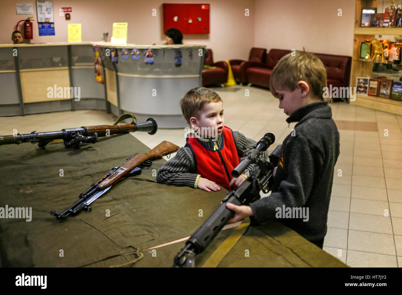 Boys Playing With Guns In A Lobby Area Stock Photo Alamy