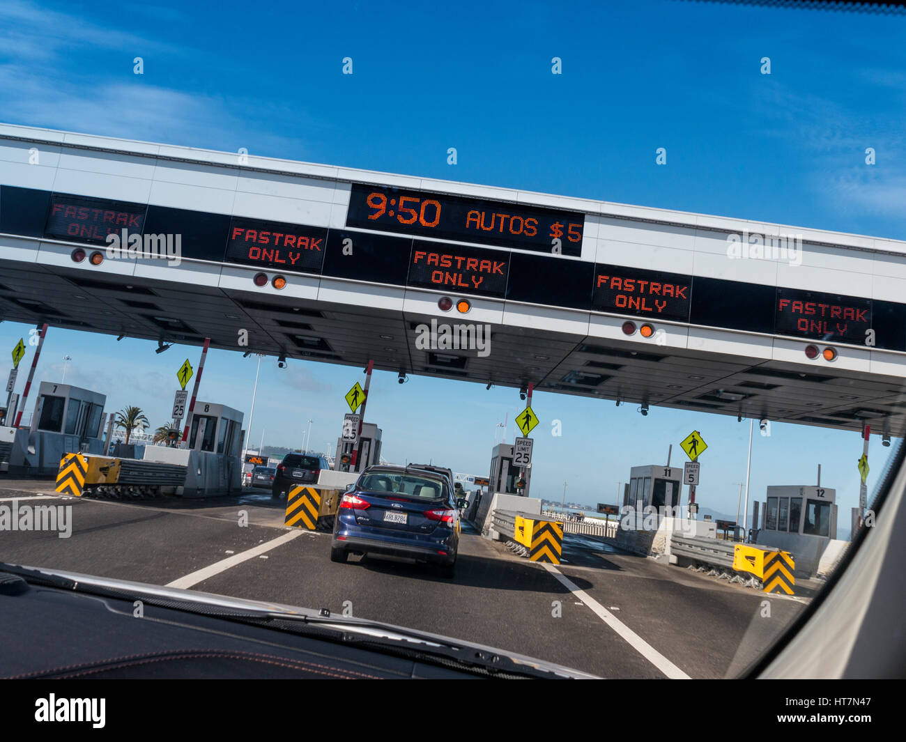 Car POV of Toll Booths and Fastrak signs on gantry over Interstate 80 highway to San Francisco City California USA Stock Photo