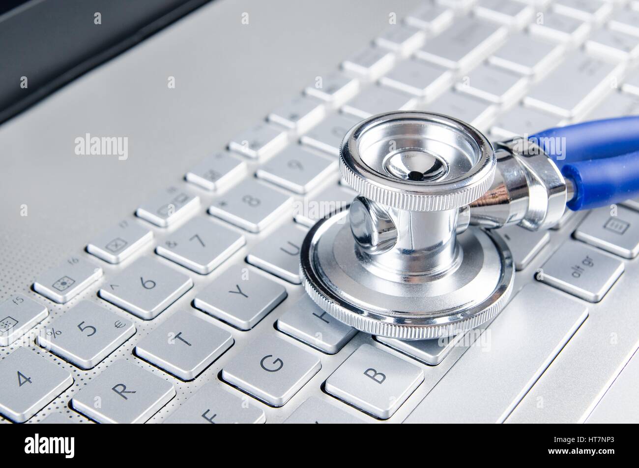 Diagnosis and repair of computers. Stethoscope on laptop Stock Photo