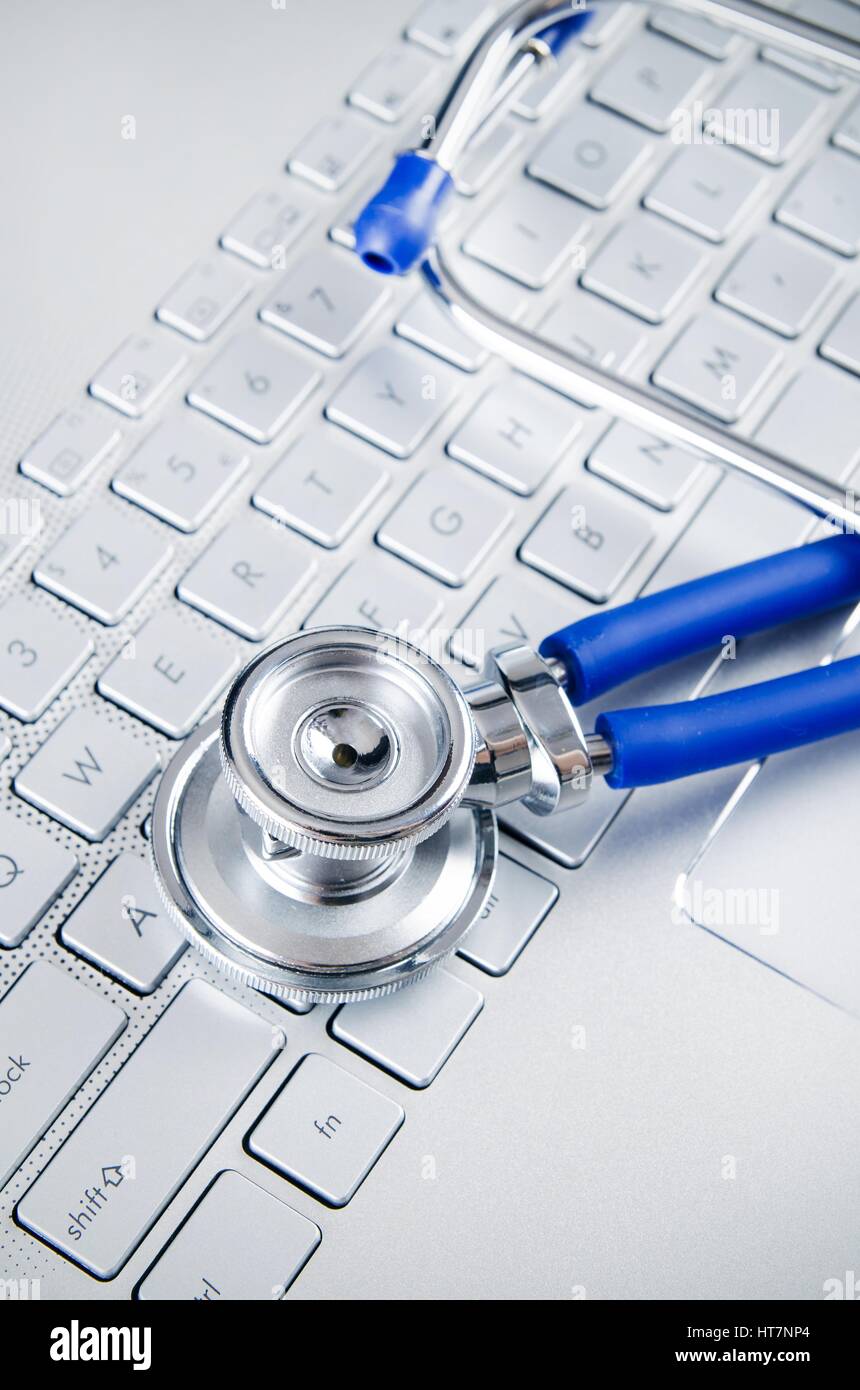 Diagnosis and repair of computers. Stethoscope on laptop Stock Photo