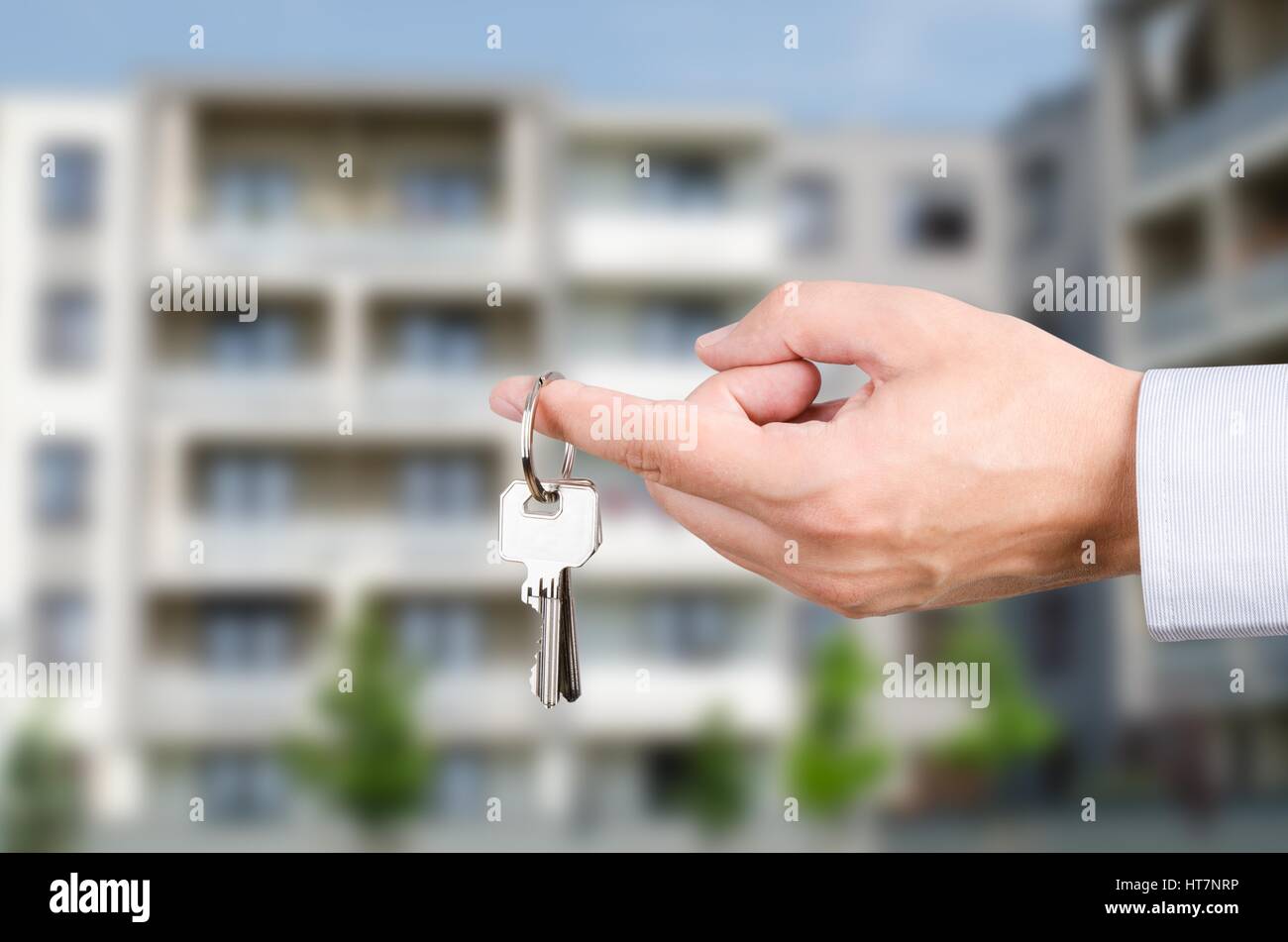 Man hand holding on finger keys to new house. Stock Photo