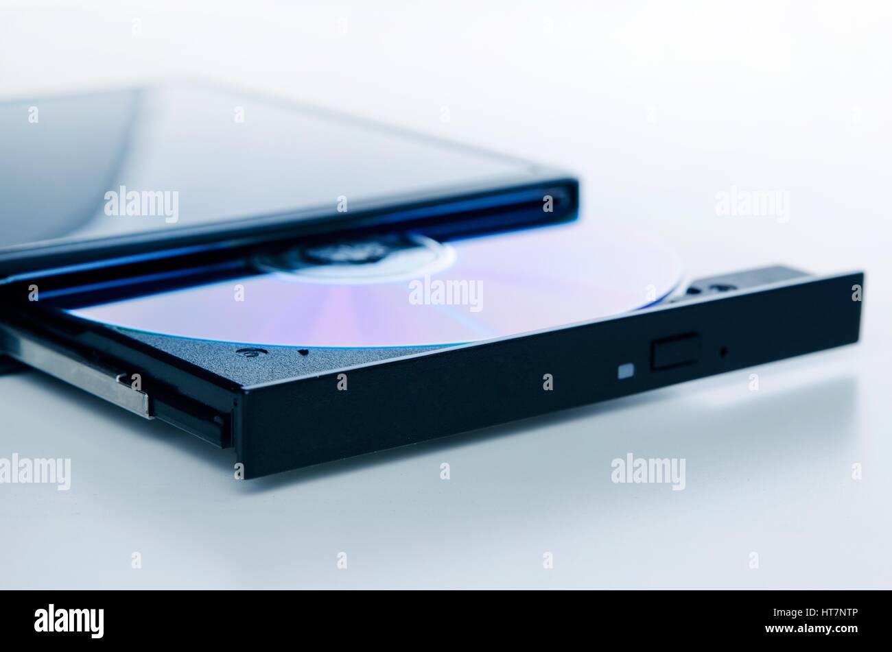 External optical disc writer. Compact device connected via USB port. CD, DVD backup data. Stock Photo