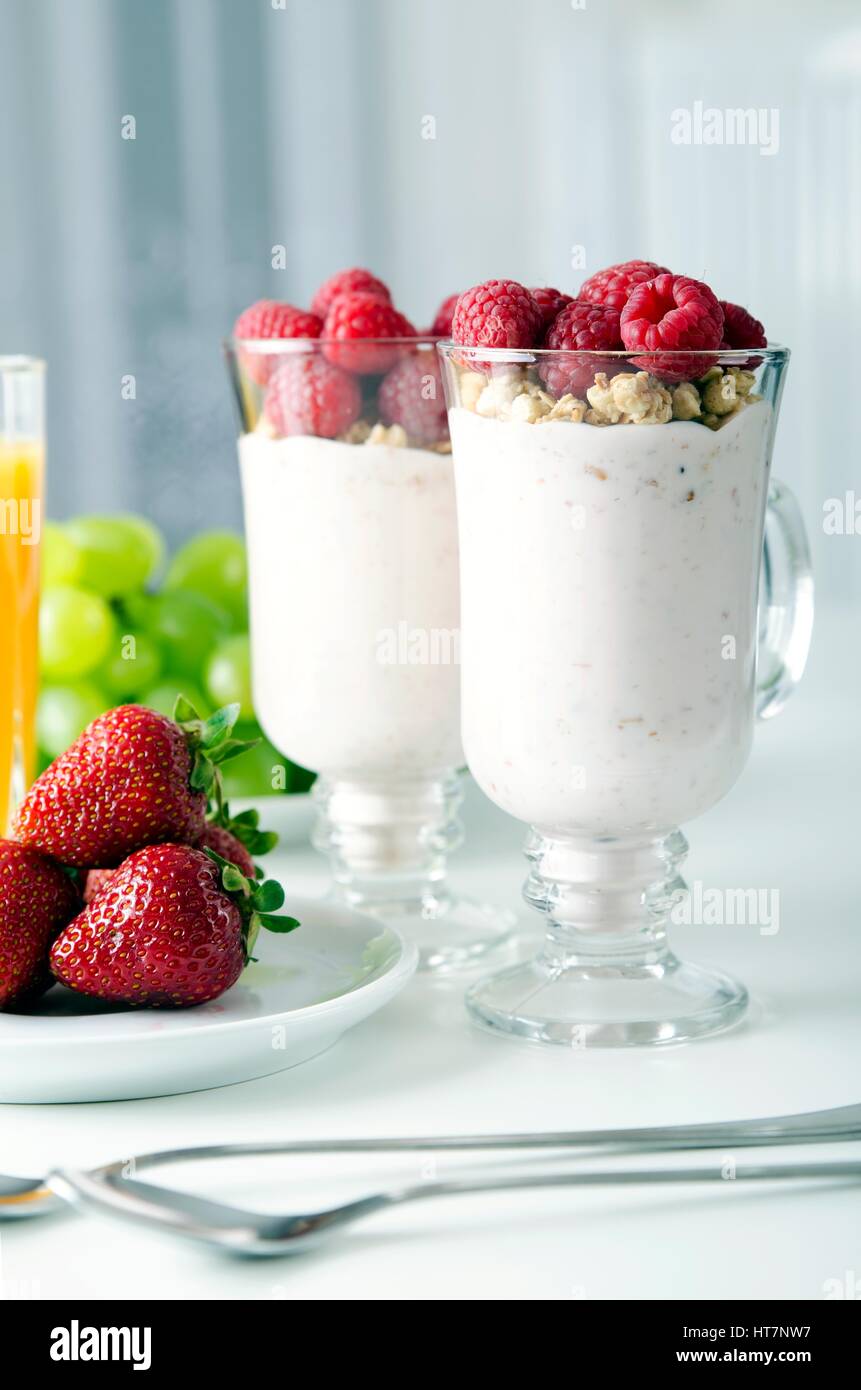 Glass of dessert with fresh berries, muesli and yoghurt on table Stock Photo