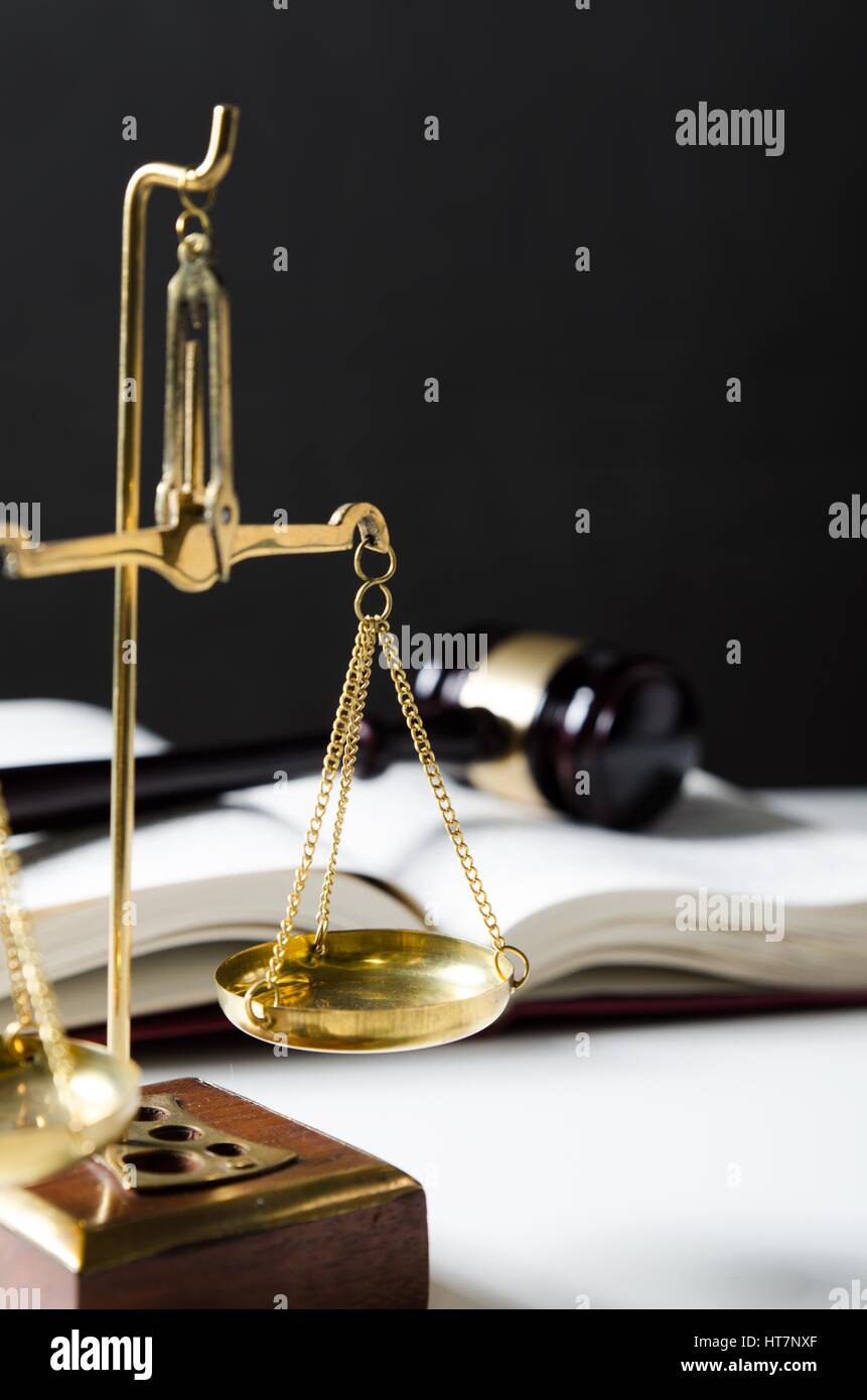 Scale of Justice. Law composition with gavel on books in background Stock Photo