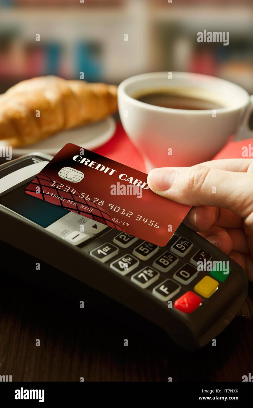 Man using payment terminal with NFC contactless technology in cafeteria Stock Photo