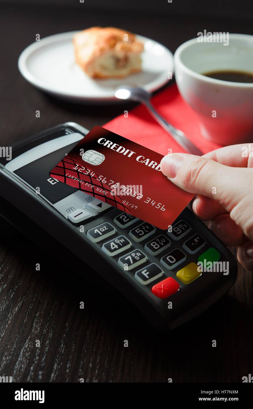 Man using payment terminal with NFC contactless technology in cafeteria Stock Photo