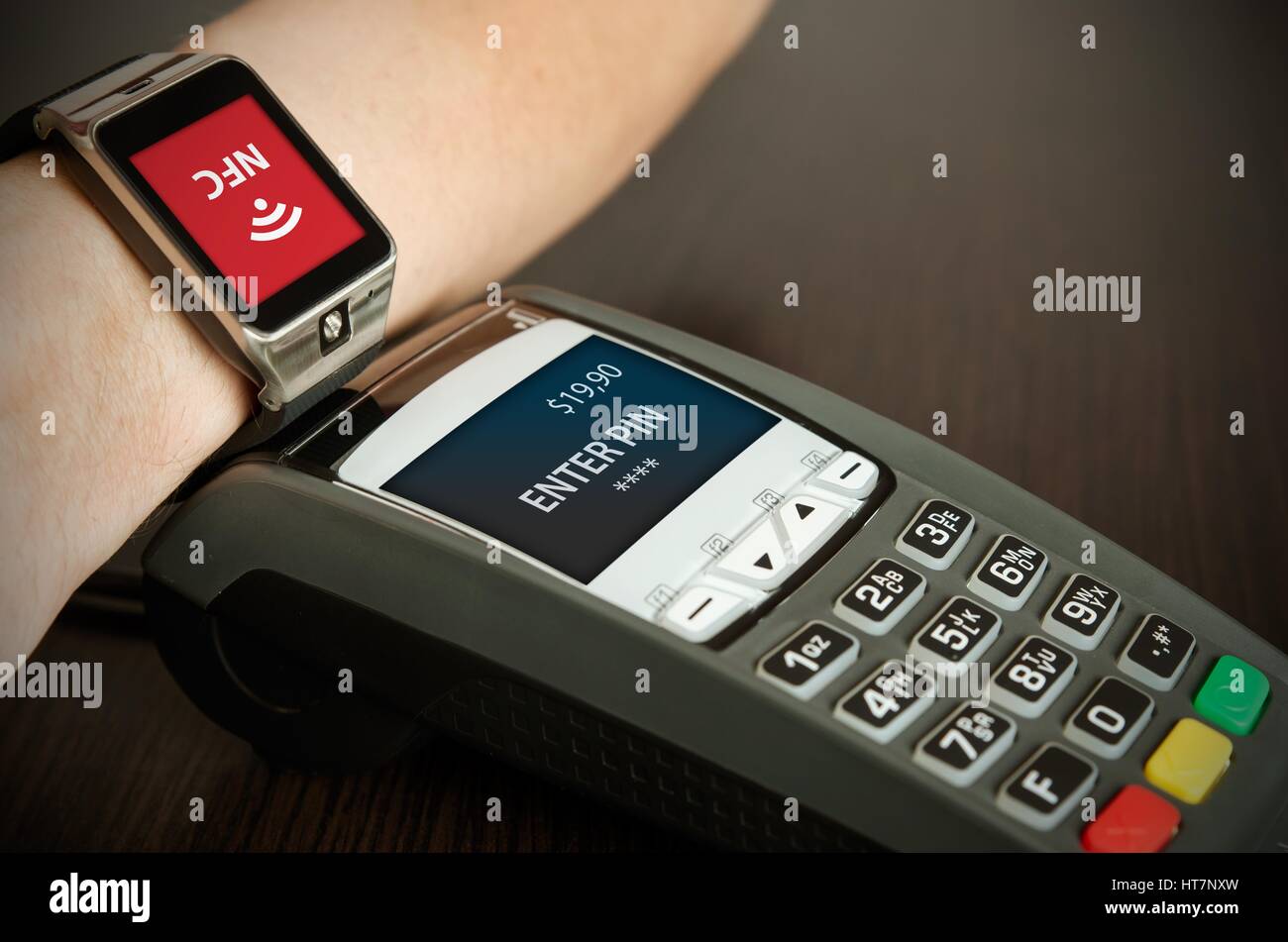 Man making payment through smartwatch via NFC contactless technology Stock Photo