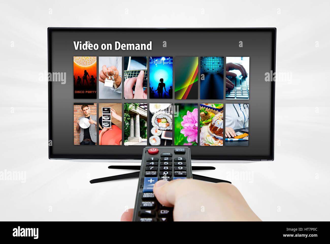 Video on demand VOD service on smart TV. Remote control in hand. Stock Photo