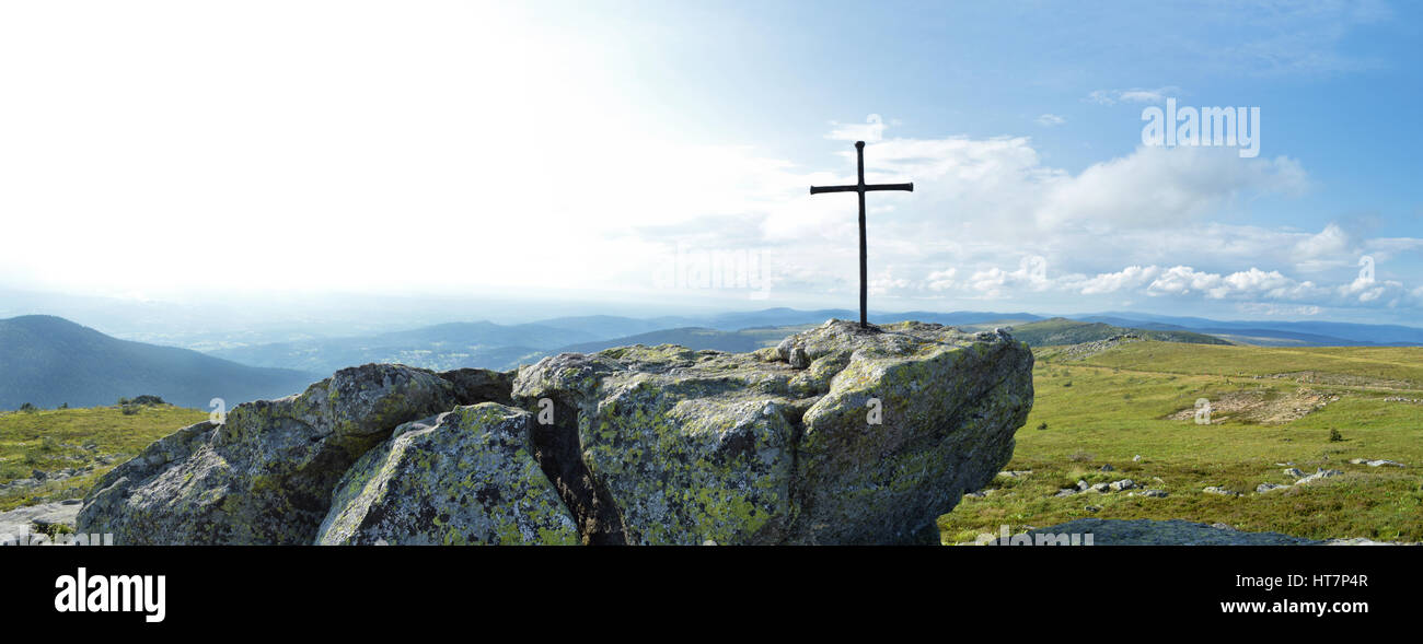 Religious cross on summit of a mountain Stock Photo