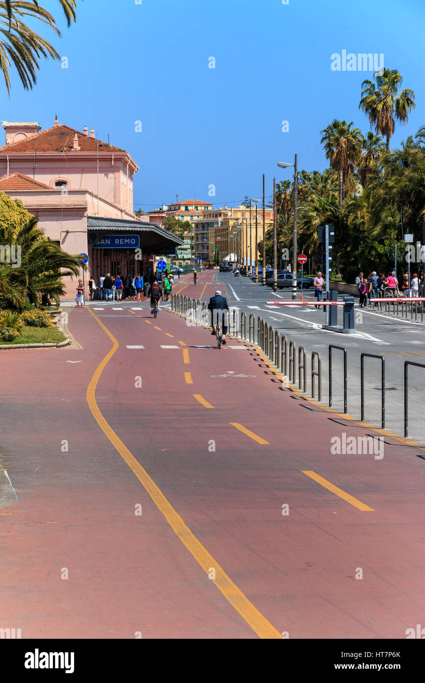 SAN REMO, ITALY - APRIL 29, 2016: People riding cicycle path near train station Stock Photo
