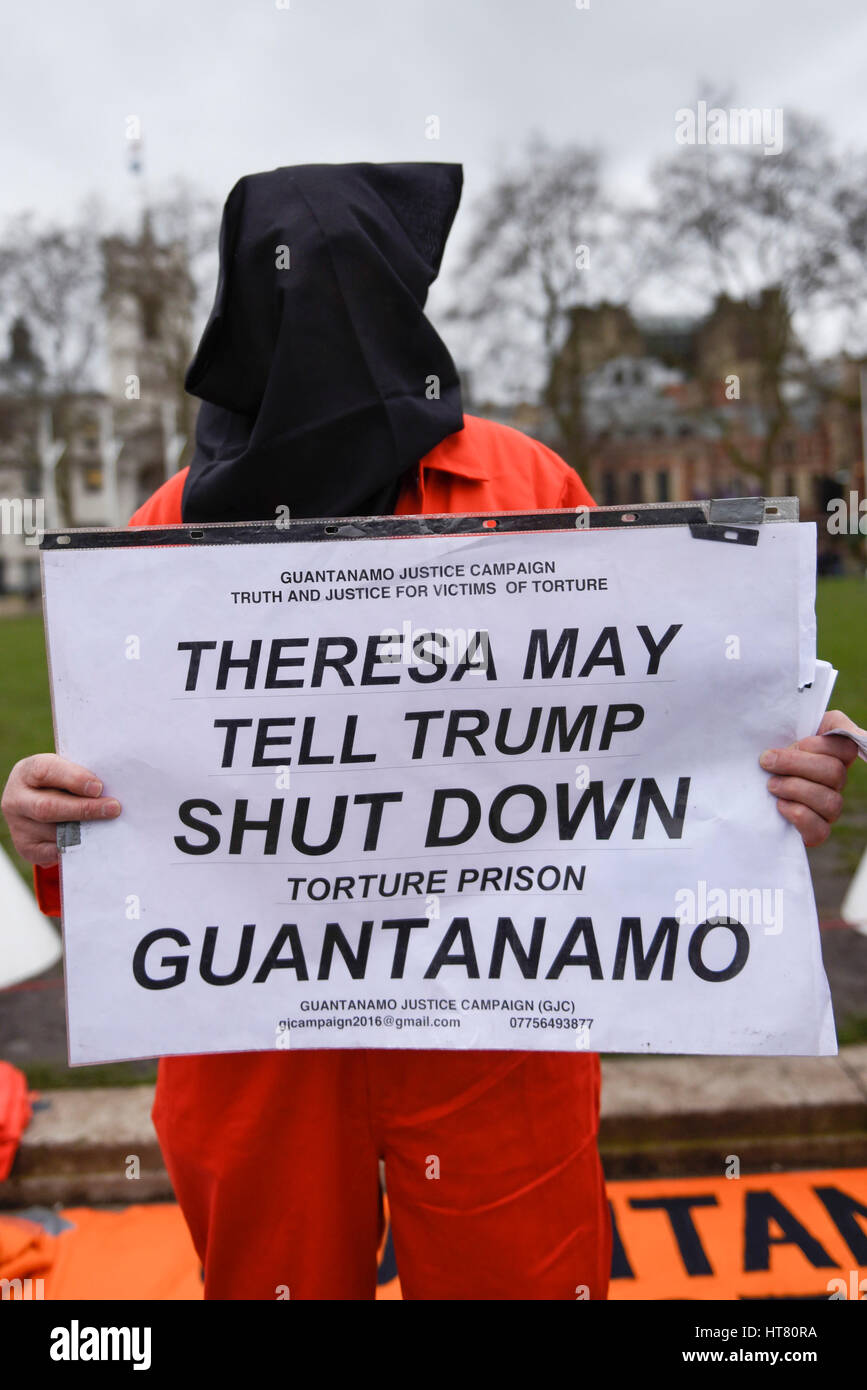 London, UK.  8 March 2017.  A member of Guantanamo Justice Campaign, wearing a prisoner's hood, takes part in a protest in Parliament Square opposite the Houses of Parliament demanding that Donald Trump, President of the United States, close Guantanamo Bay concentration camp and calling on Theresa May, Prime Minister, to seek representations from President Trump that it will be a closure, not a relocation to a mainland US prison.  Credit: Stephen Chung / Alamy Live News Stock Photo