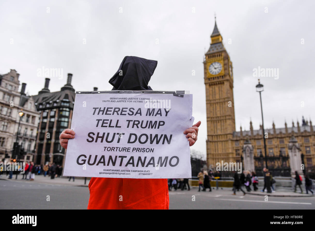 London, UK.  8 March 2017.  A member of Guantanamo Justice Campaign, wearing a prisoner's hood, takes part in a protest in Parliament Square opposite the Houses of Parliament demanding that Donald Trump, President of the United States, close Guantanamo Bay concentration camp and calling on Theresa May, Prime Minister, to seek representations from President Trump that it will be a closure, not a relocation to a mainland US prison.  Credit: Stephen Chung / Alamy Live News Stock Photo