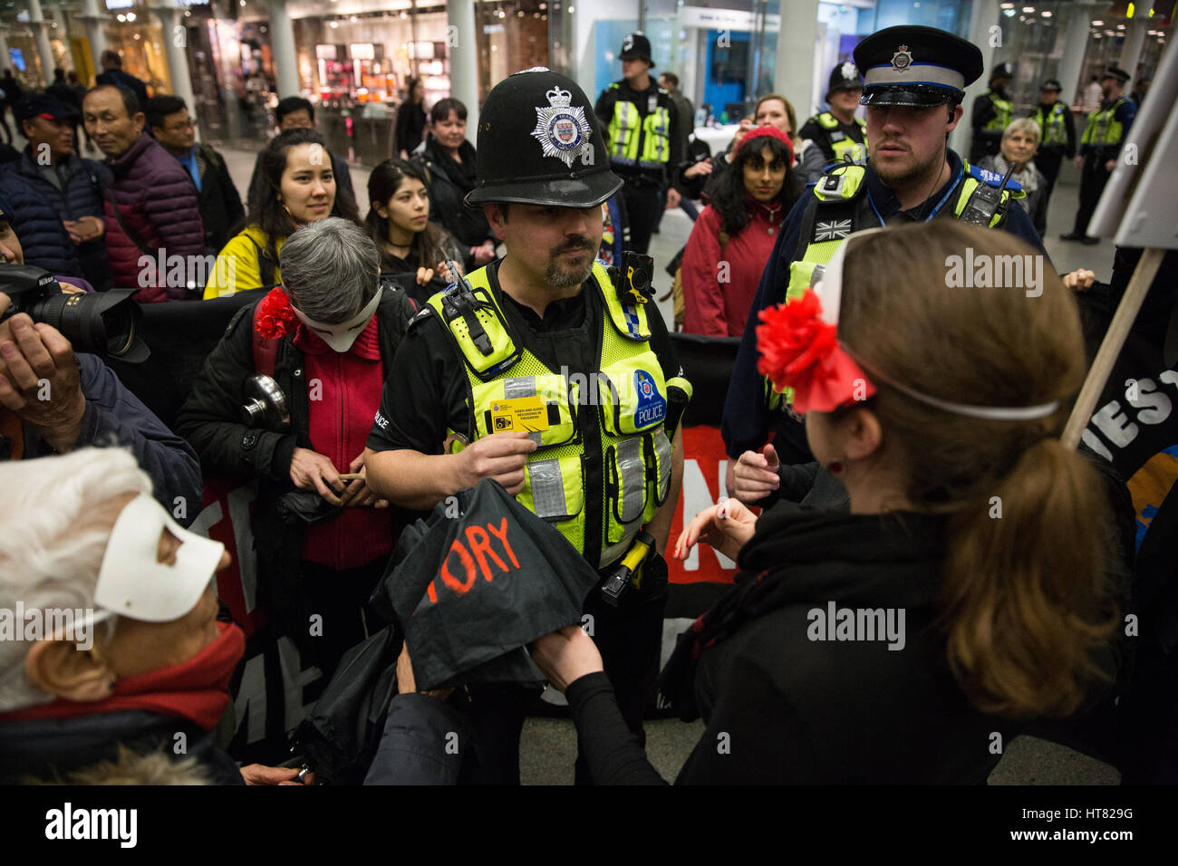London, UK. 8th March, 2017. Police ask about the performance by women from Global Women's Strike, Women's Strike UK and Polish feminists at St Pancras station to coincide with International Women's Day and the International Women's Strike. Credit: Mark Kerrison/Alamy Live News Stock Photo