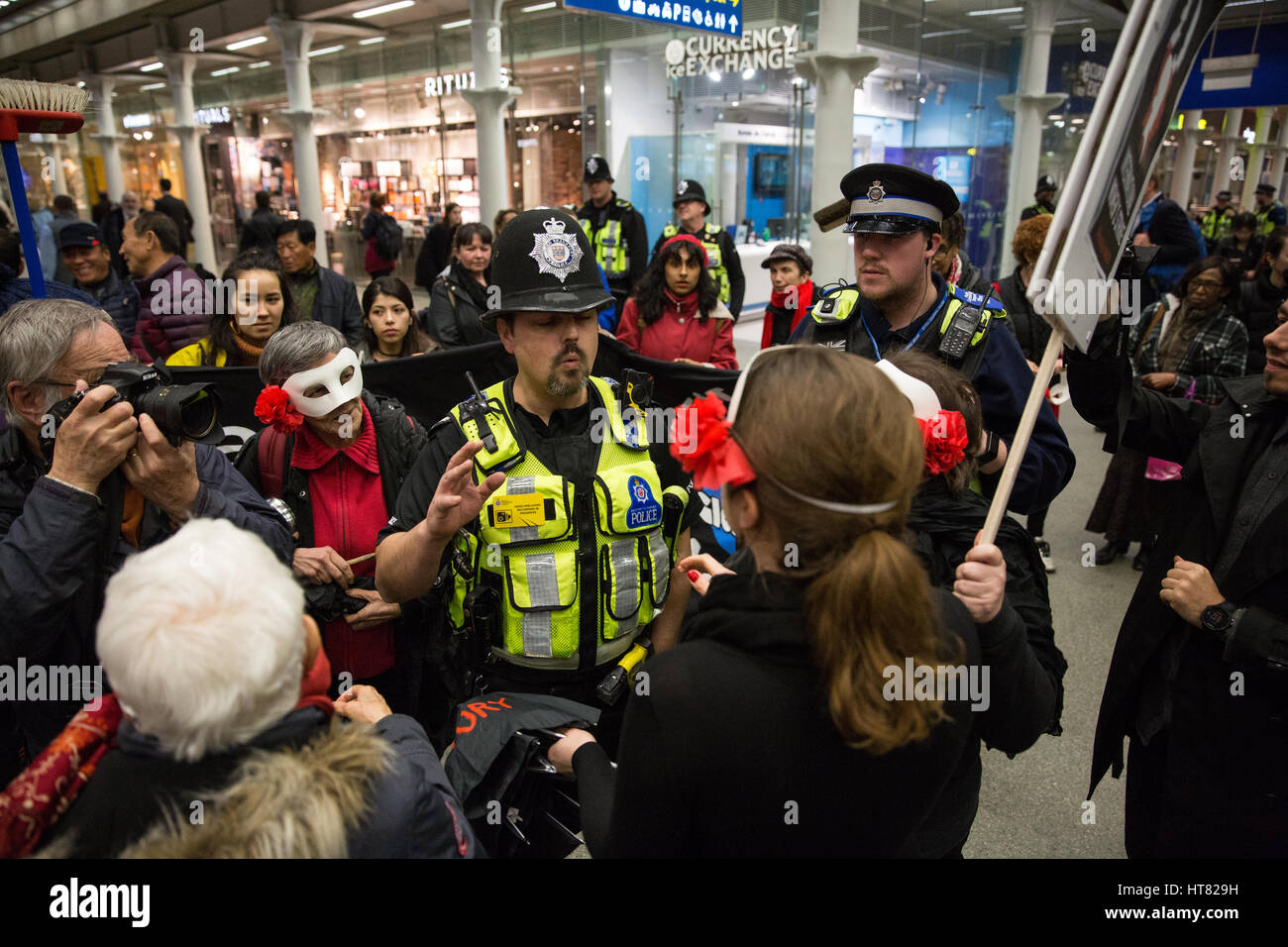 London, UK. 8th March, 2017. Police ask about the performance by women from Global Women's Strike, Women's Strike UK and Polish feminists at St Pancras station to coincide with International Women's Day and the International Women's Strike. Credit: Mark Kerrison/Alamy Live News Stock Photo