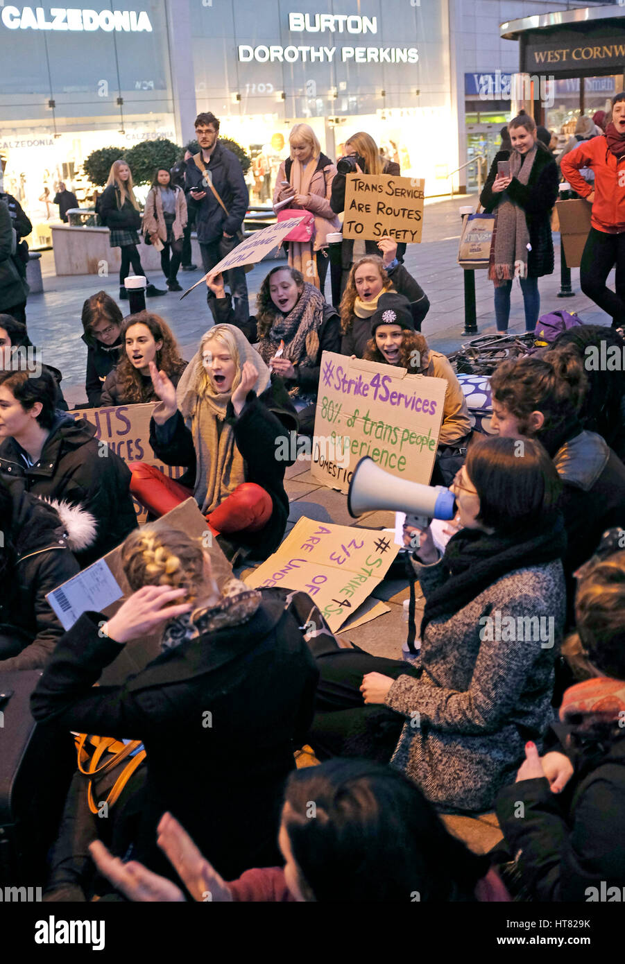 Brighton, UK. 8th Mar, 2017. Members of Sisters Uncut Brighton hold a sit down protest in the city centre in solidarity with the International Women's Strike Movement to highlight cuts to Domestic Violence Services . The protest was held on the same day as Chancellor Phillip Hammonds budget speech Credit: Simon Dack/Alamy Live News Stock Photo