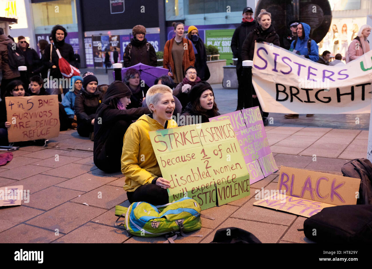 Brighton, UK. 8th Mar, 2017. Members of Sisters Uncut Brighton hold a sit down protest in the city centre in solidarity with the International Women's Strike Movement to highlight cuts to Domestic Violence Services . The protest was held on the same day as Chancellor Phillip Hammonds budget speech Credit: Simon Dack/Alamy Live News Stock Photo
