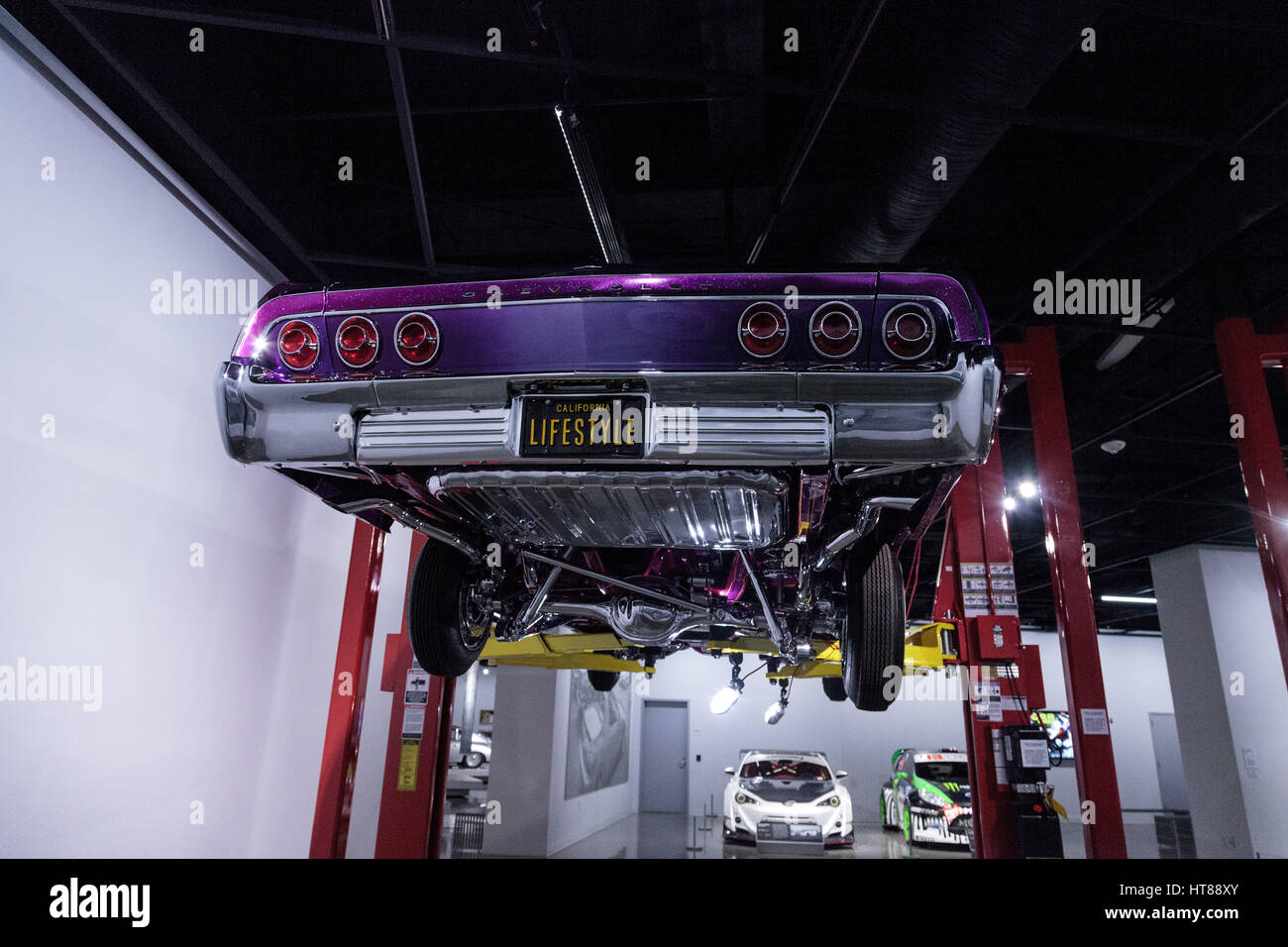 Los Angeles, CA, USA — March 4, 2017: Purple and pink 1964 Chevrolet Impala called Sinful Sin at the Petersen Automotive Museum in Los Angeles, Califo Stock Photo