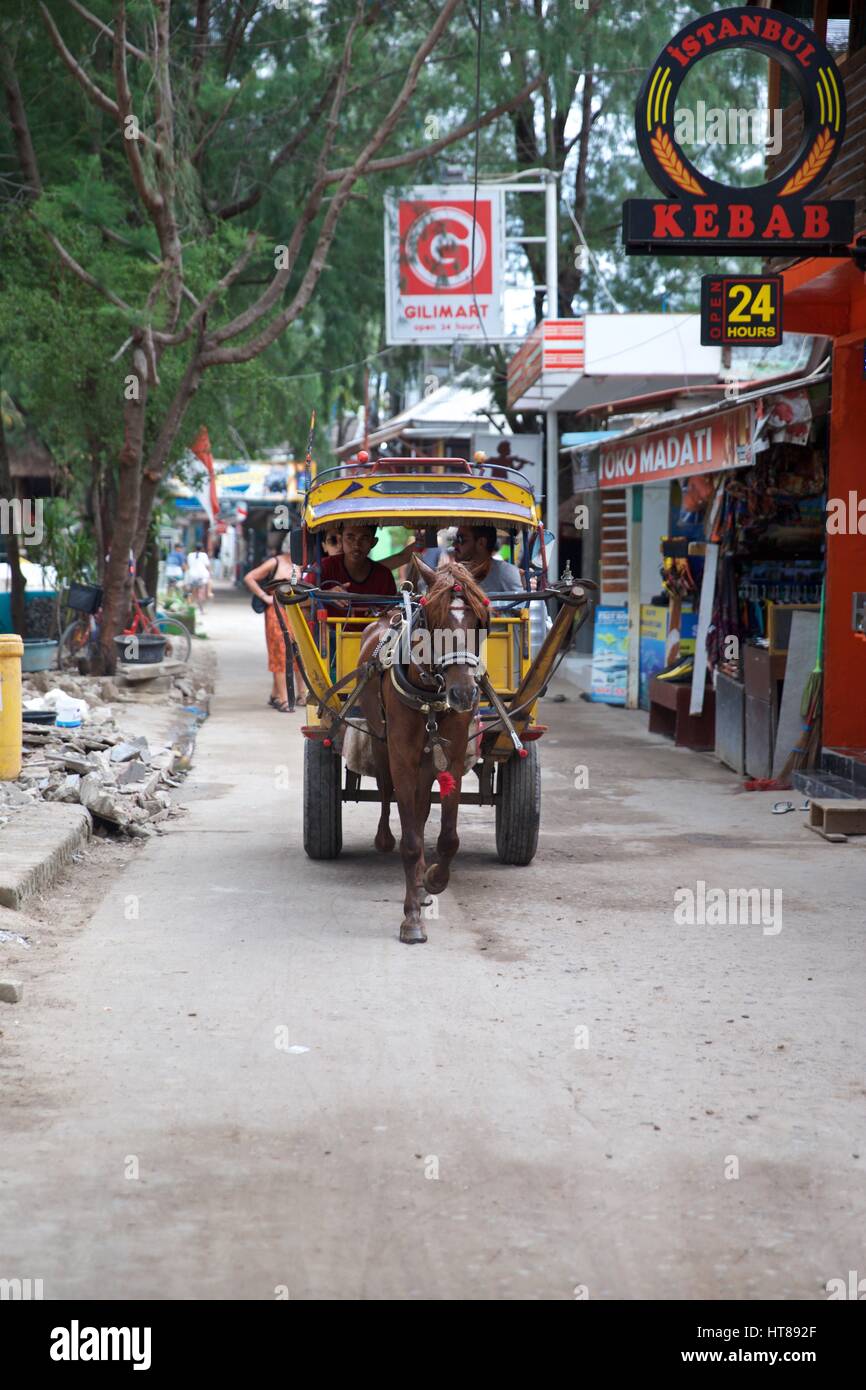 Traditional horse drawn wooden yellow cart on Gili T in Indonesia Stock Photo