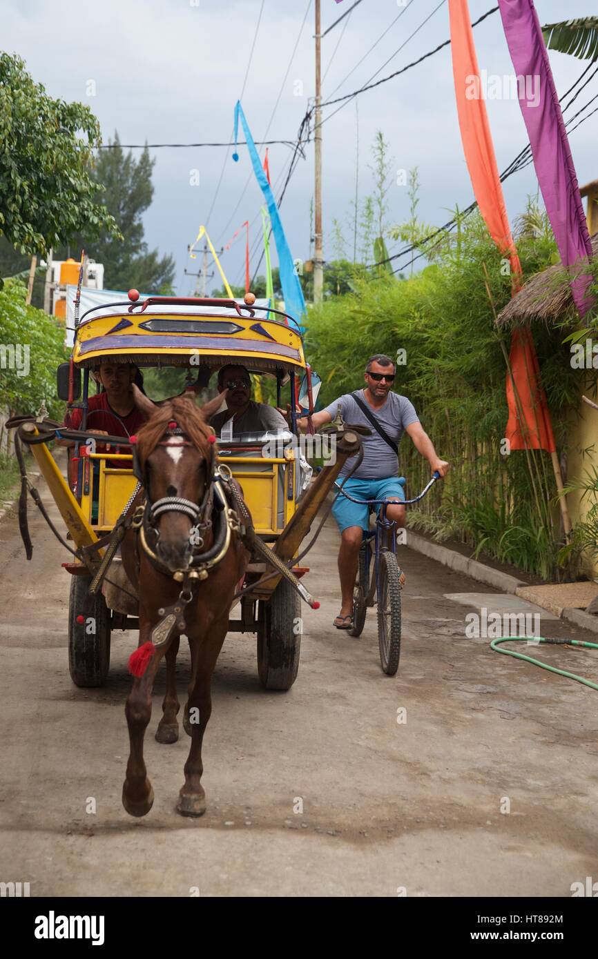 Traditional horse drawn wooden yellow cart on Gili T in Indonesia Stock Photo