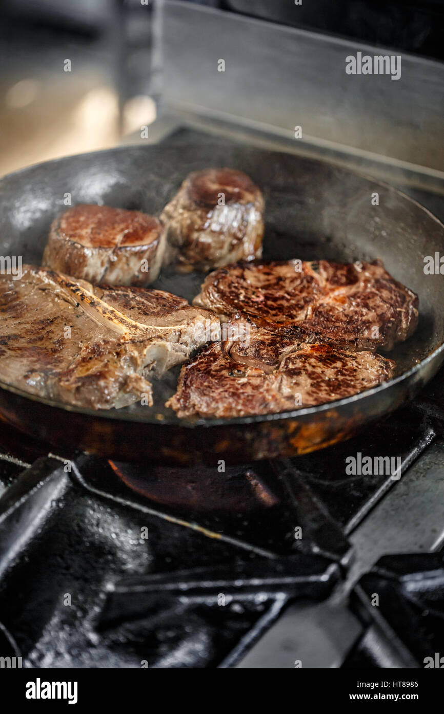 Juicy grilled steaks in a frying pan Stock Photo Alamy