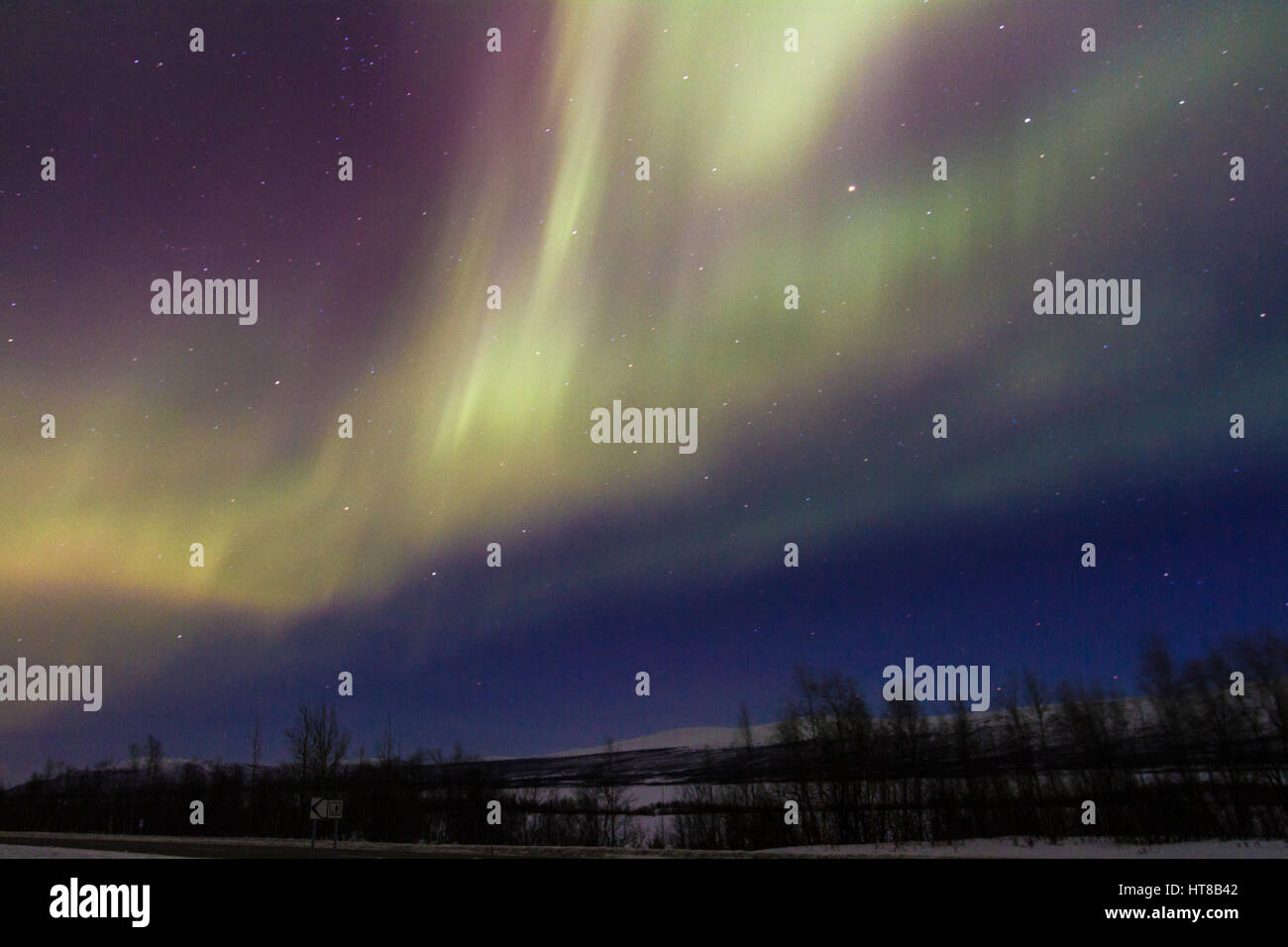 Northern light, Aurora borealis, mountains in background, auroa are violett, green, winter season, Kiruna, Swedish Lapland, Sweden Stock Photo