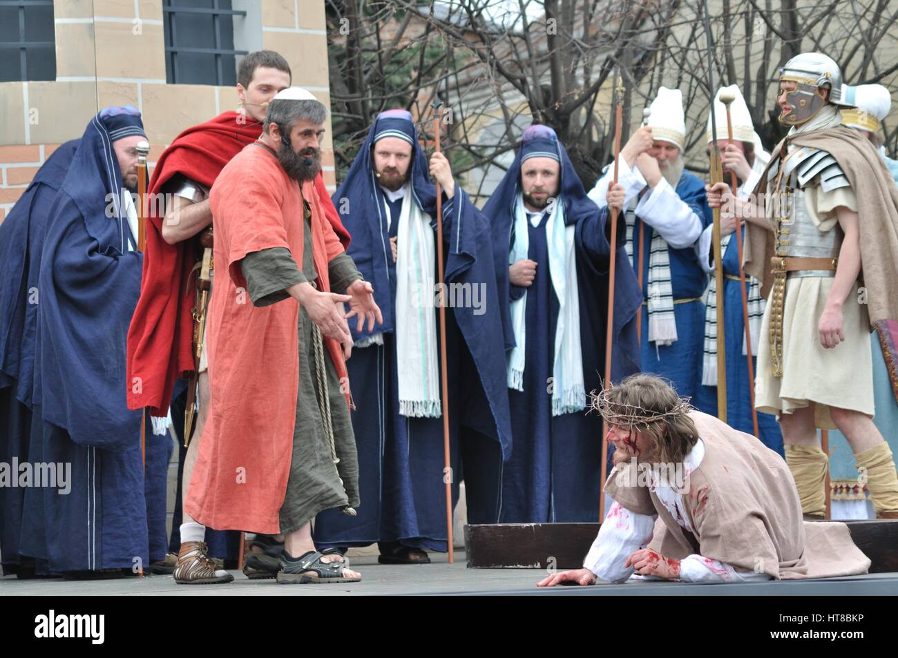 Jesus falls on the way to his crucifixion, during the street performances Mystery of the Passion. Stock Photo