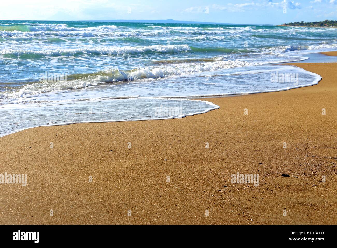 foamy wave of the sea splashing on a sandy beach Stock Photo - Alamy