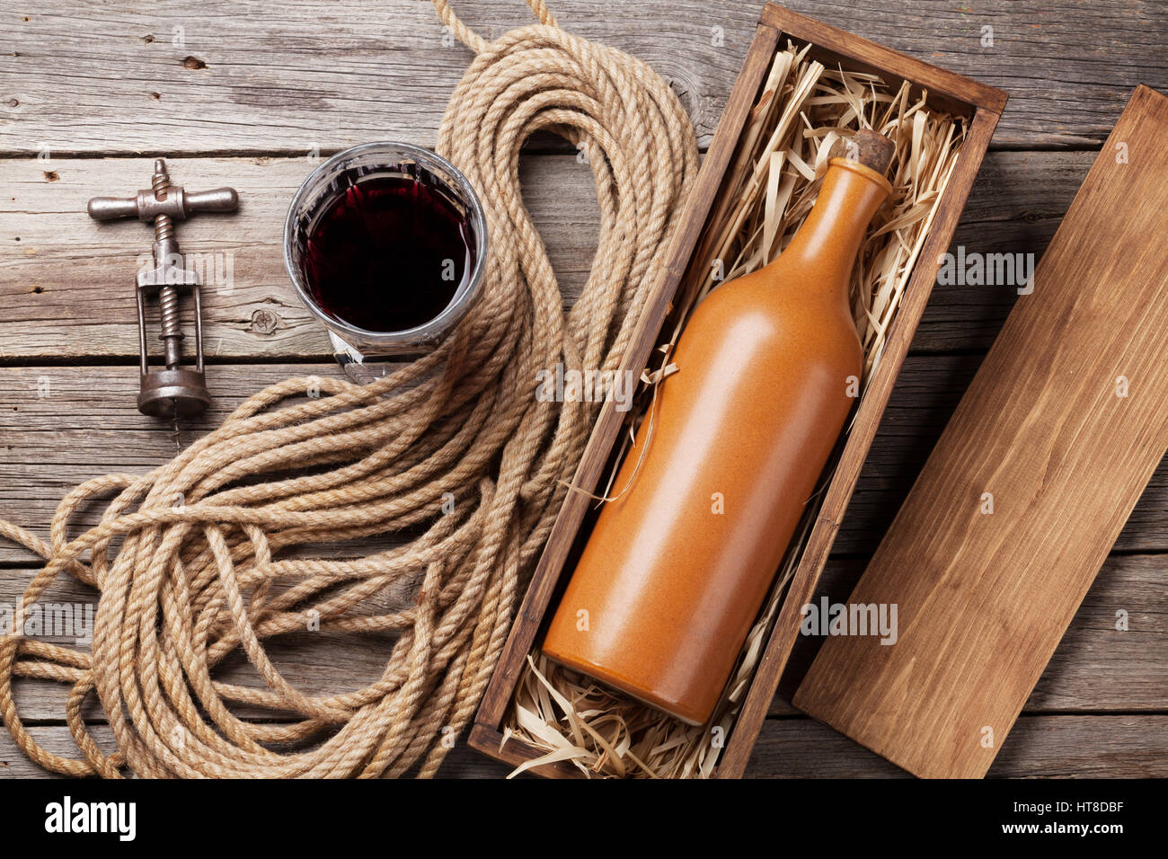 Red wine bottle and glass on wooden table. Top view Stock Photo - Alamy