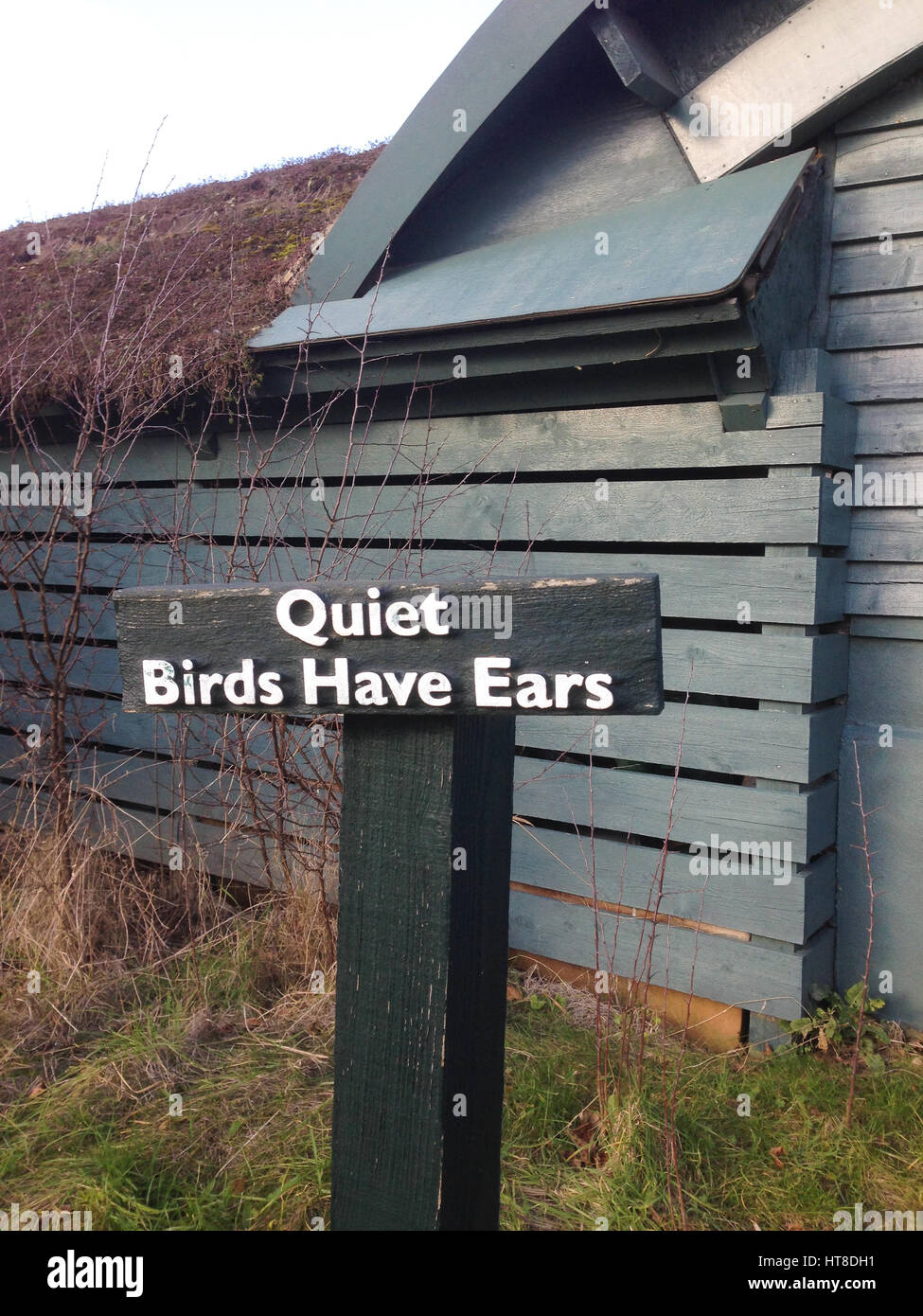 Sign Quiet Birds Have Ears outside birdwatching hide in London Wetland