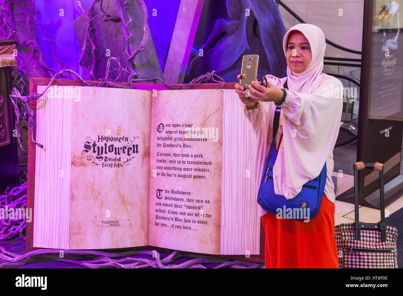 China, Hong Kong, Causeway Bay, Indonesian Woman Taking Selfie Photo with Store Halloween Decoration Stock Photo
