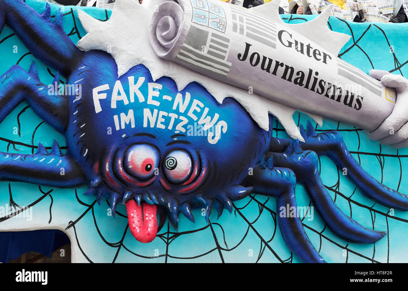 Spider in the web, good journalism beating Fake News, paper mache figure, political cartoon, motto Cart Carnival Monday Stock Photo