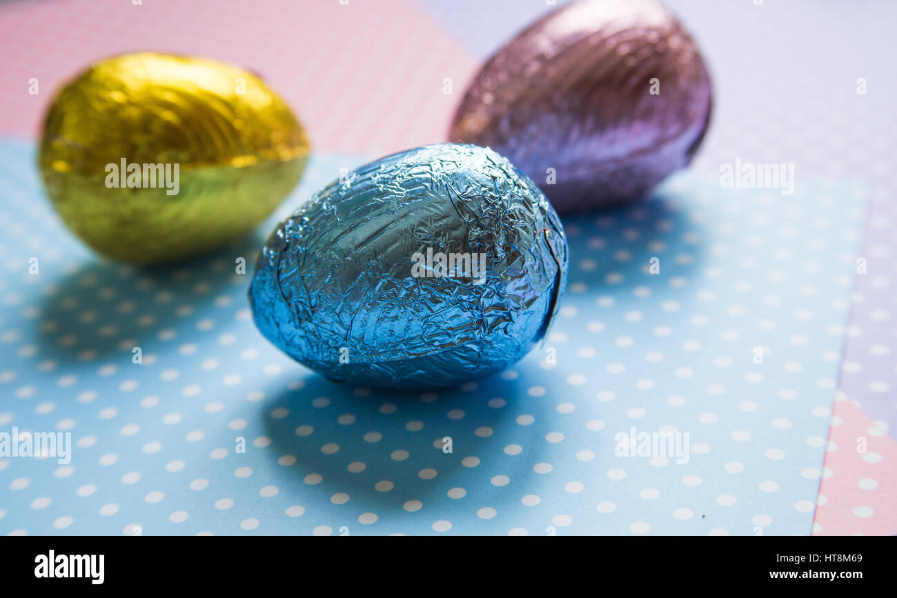 Easter eggs wrapped in coloured foil Stock Photo - Alamy