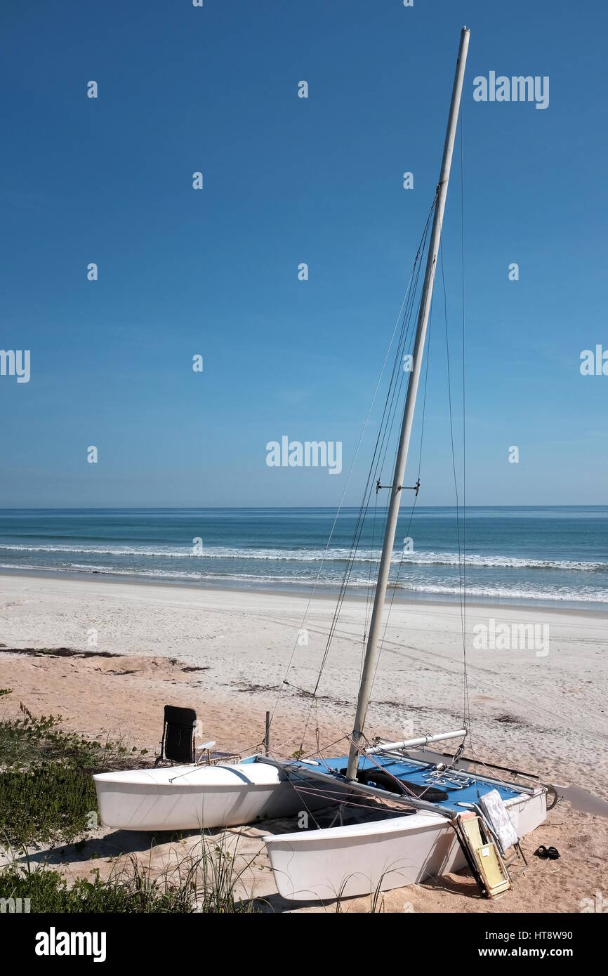A beached catamaran at pristine Bethune Beach seems to eagerly wait for a willing crew to head out to sea and sail away on many coastal adventures. Stock Photo