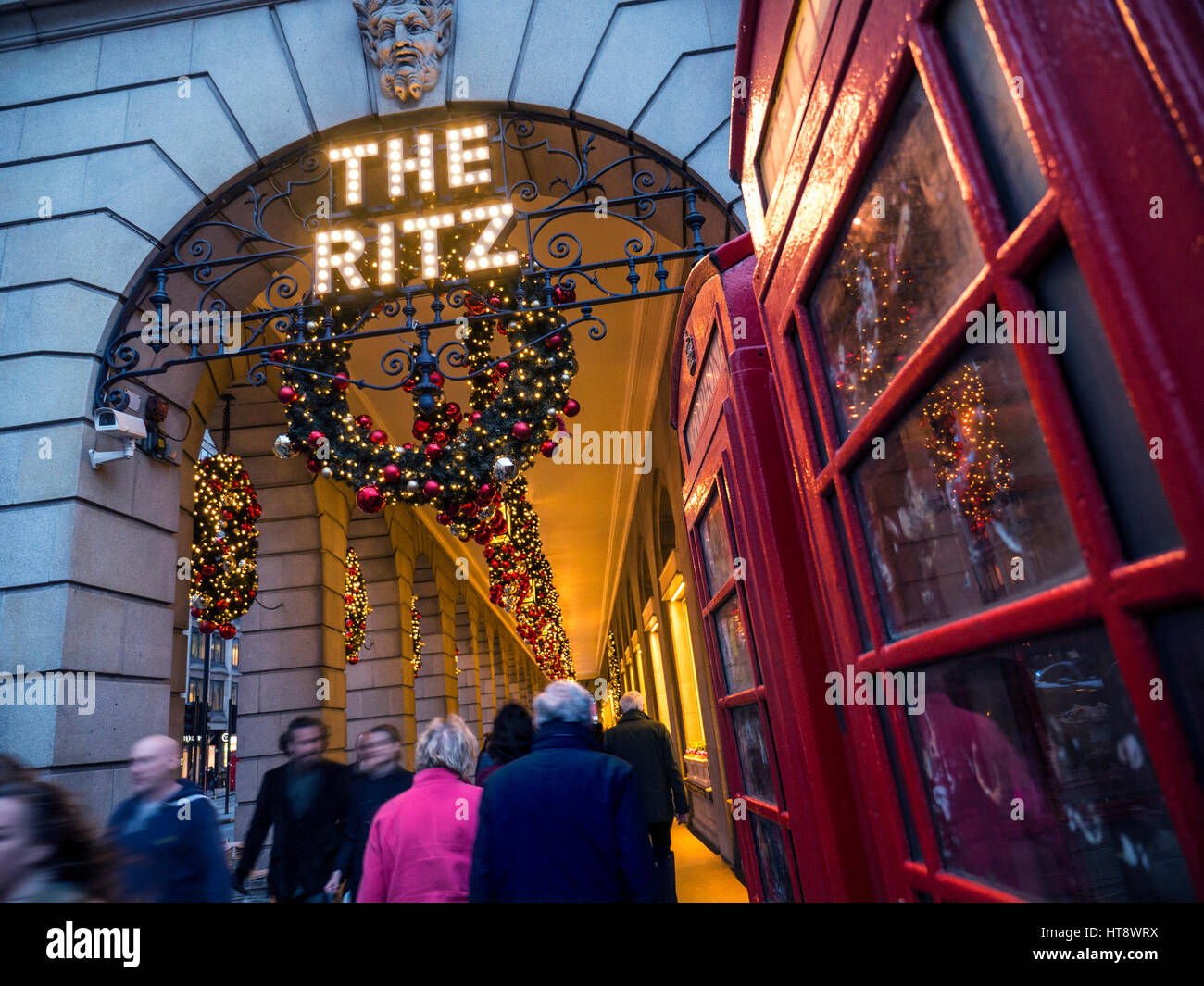 The Ritz Hotel at dusk Christmas decorations red telephone box Piccadilly London UK Stock Photo