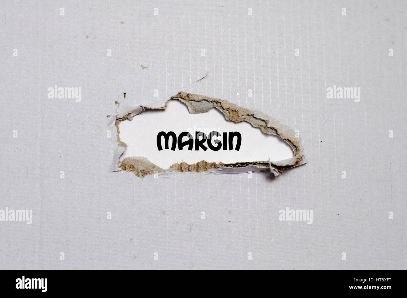 Mirgin Paper The word margin appearing behind torn paper Stock Photo - Alamy