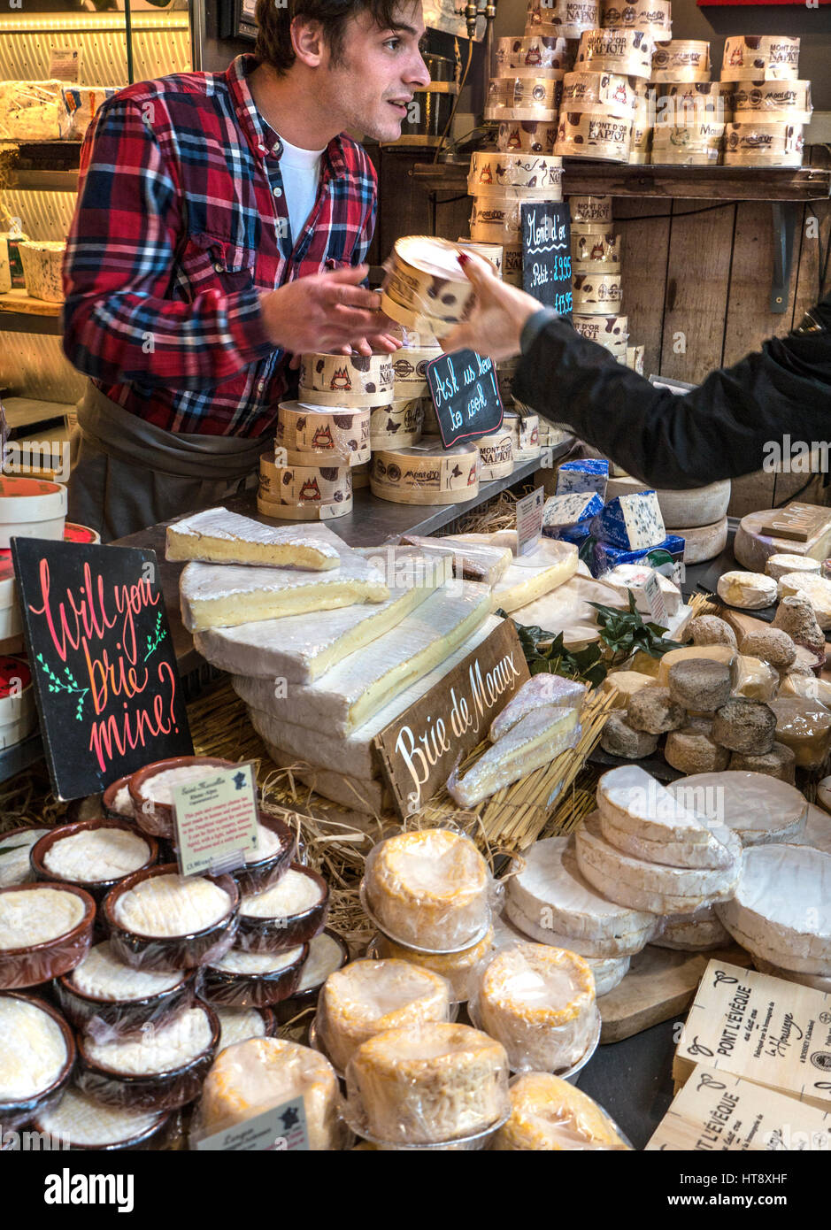 Authentic friendly charming French cheese market stall display at