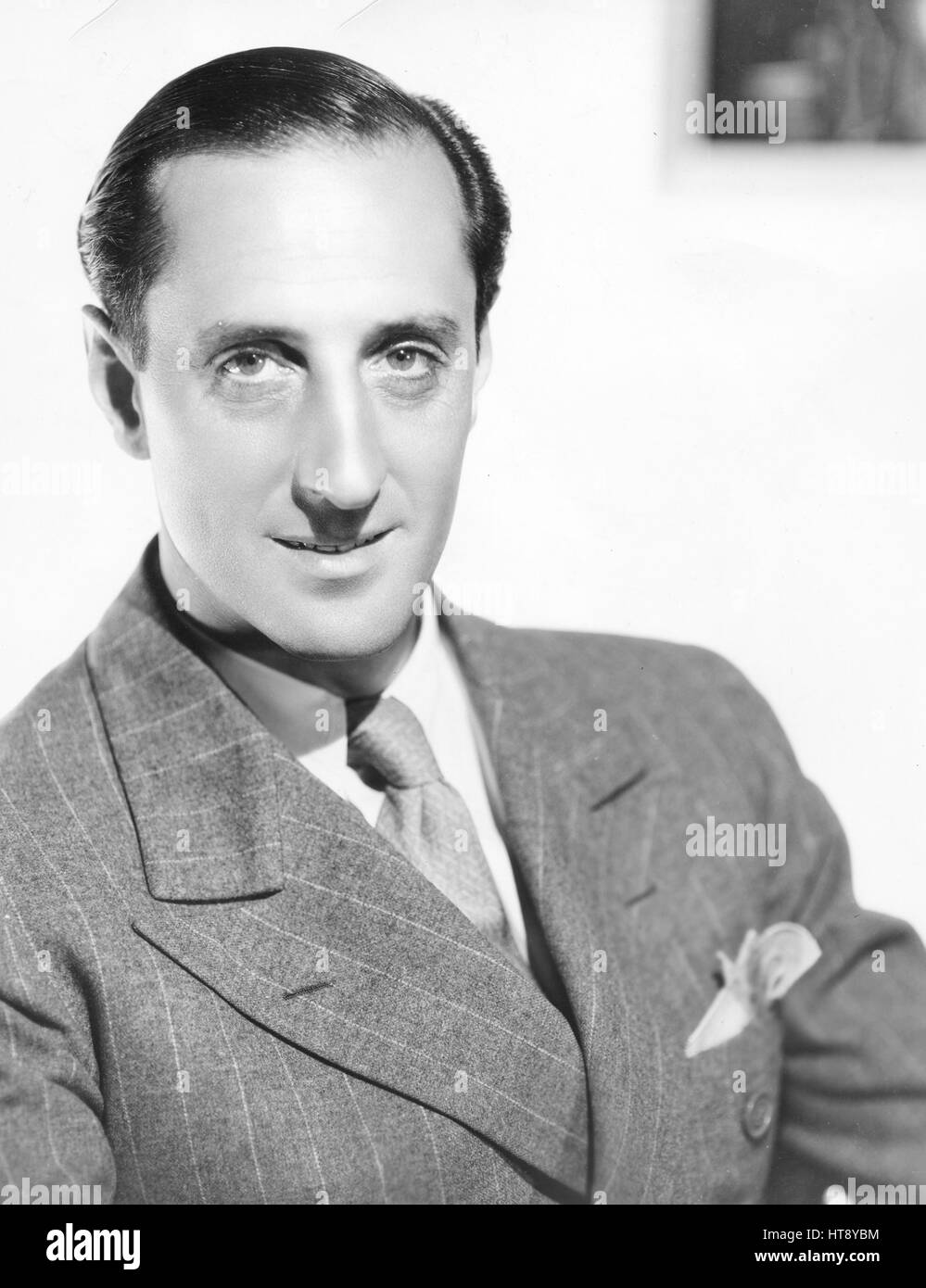 'Basil Rathbone, internationally known on the stage, turns to the screen after a four-year absence, to create the role of Mr. Edward Murdstone, the stern step-father of 'David Copperfield.' The Dickens' masterpiece is being produced by David O. Selznick at the Metro-Goldwyn-Mayer studios, under the direction of George Cukor.' Stock Photo